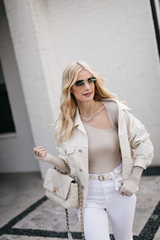 Dallas style blogger wearing a cut out neutral bodysuit and white denim