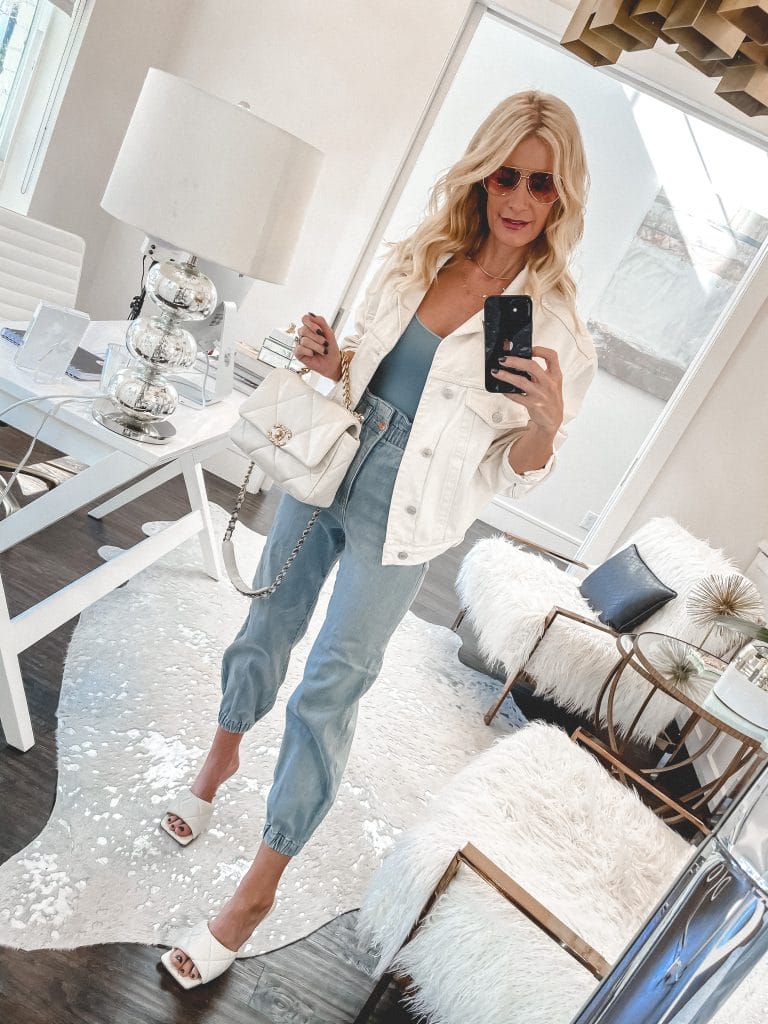 Dallas blogger wearing a white denim jacket and denim joggers