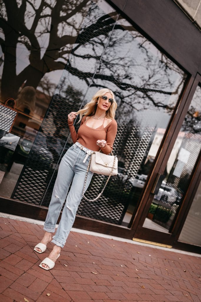 Dallas fashion blogger wearing light wash denim and a rust colored top for spring 