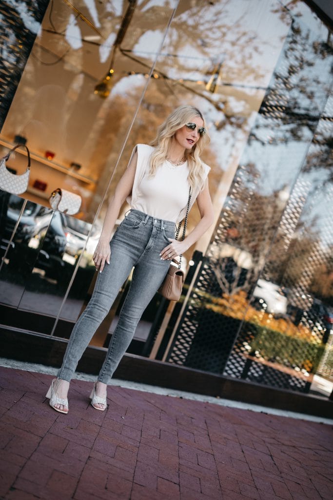 Dallas blogger wearing a neutral bodysuit and grey light wash denim