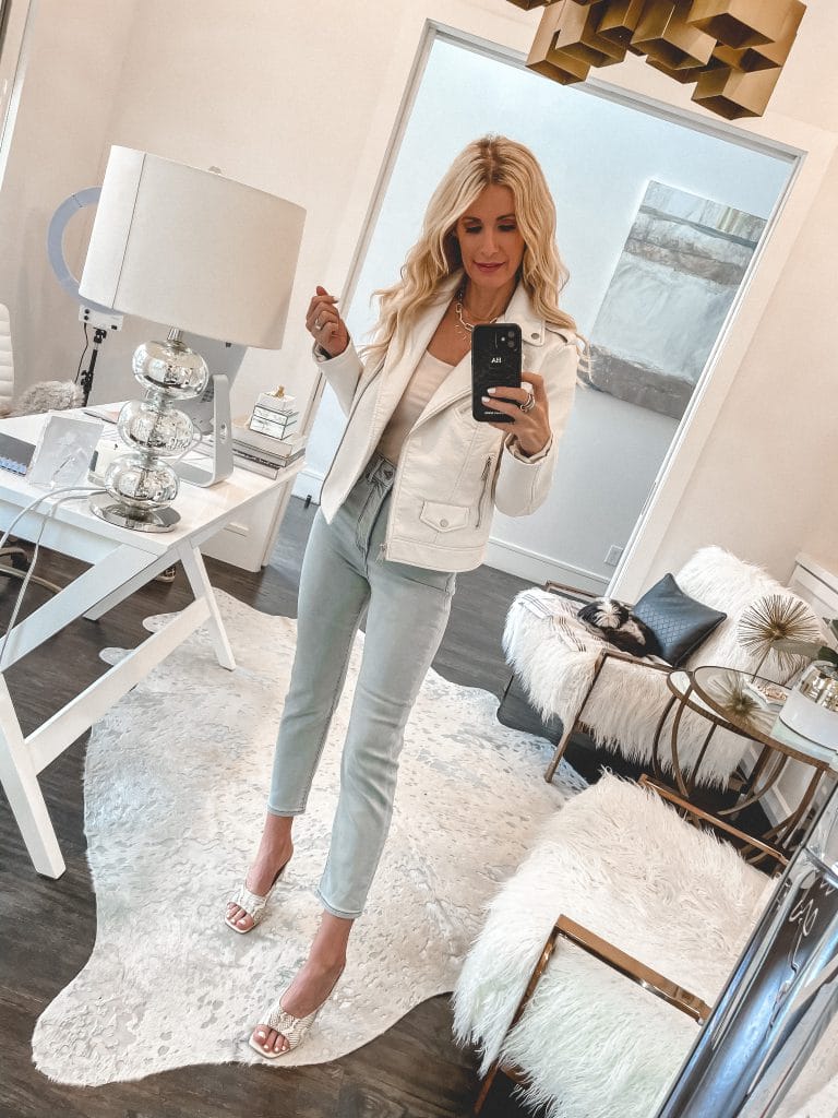 Dallas style blogger wearing light wash denim and a white jacket for spring
