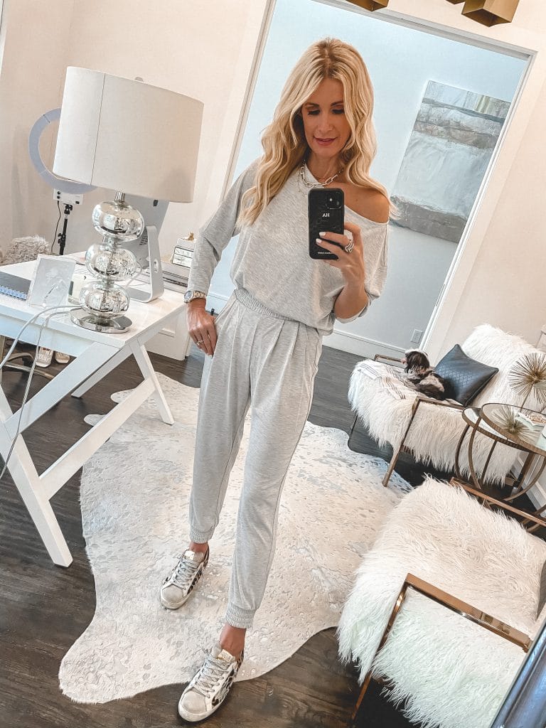 Fashion blogger wearing a light grey loungewear set and Golden Goose sneakers 
