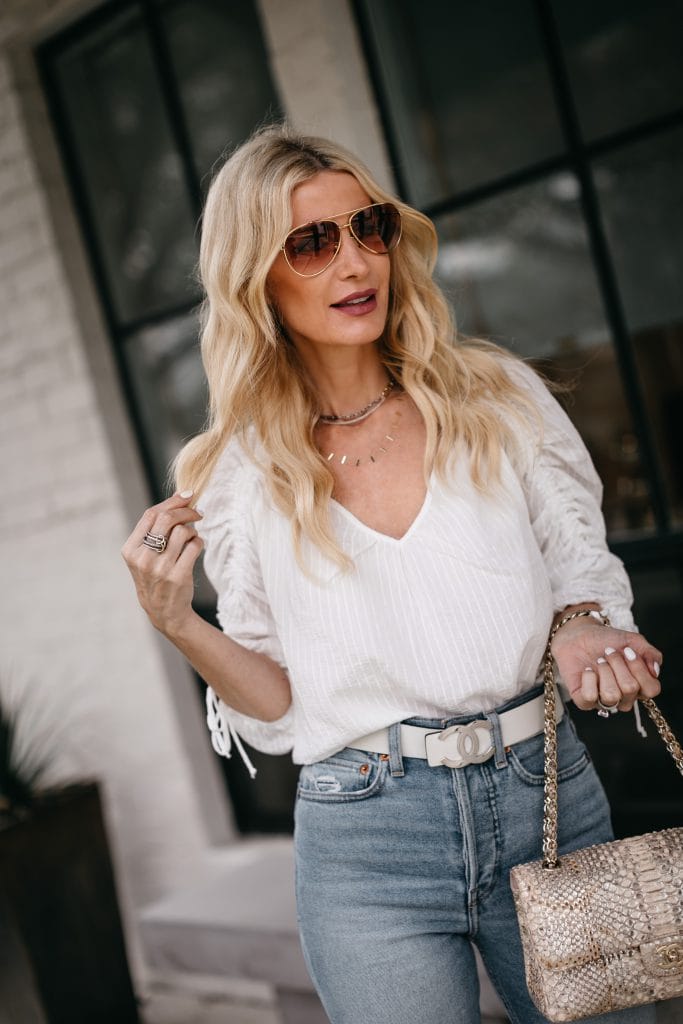 Dallas fashion blogger wearing a ruched white top and light blue denim