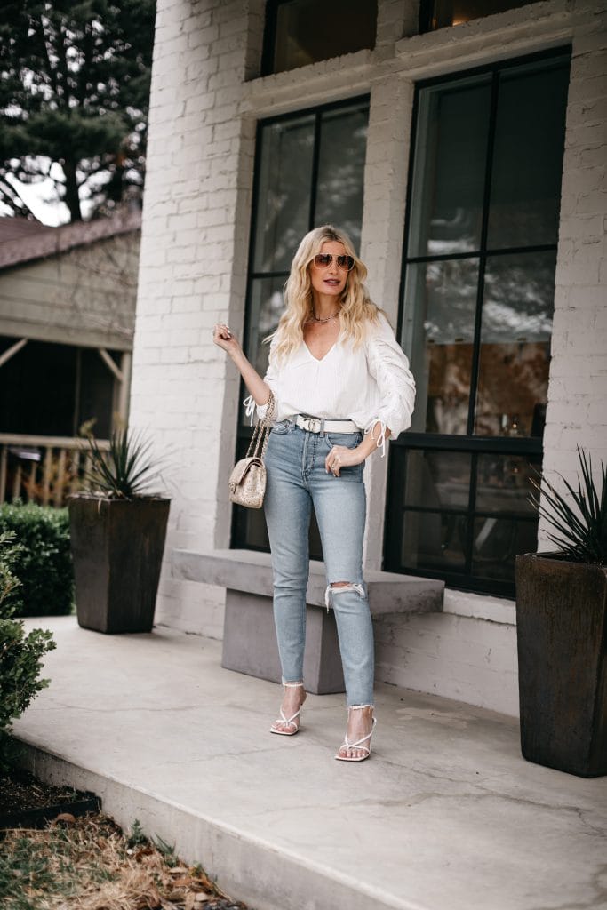 Dallas style blogger wearing a white top and denim with white strappy sandals for summer