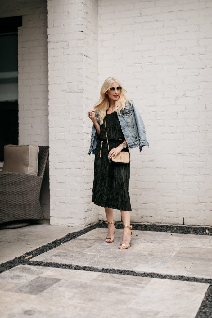 Dallas fashion blogger wearing a denim jacket, a chic dress, and gold heels for spring and summer