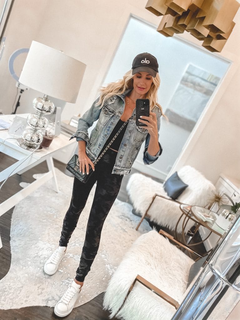 So heather blog wearing a chic denim jacket and workout joggers with white sneakers 