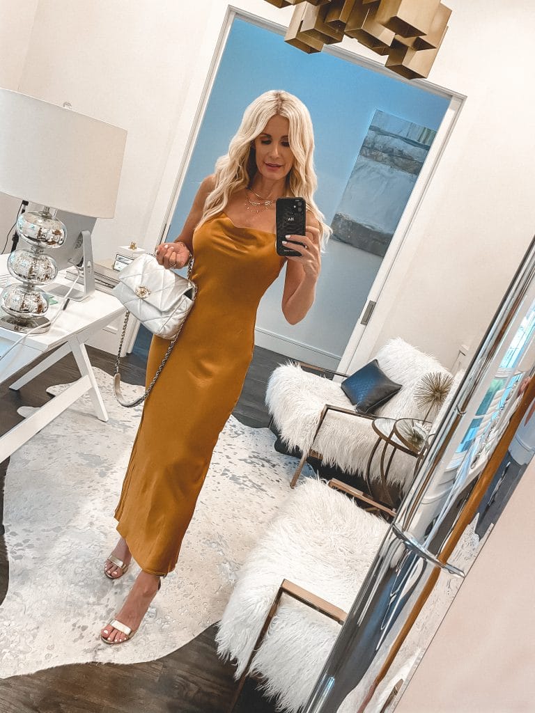 Dallas blogger wearing a silk bodycon dress and gold shoes