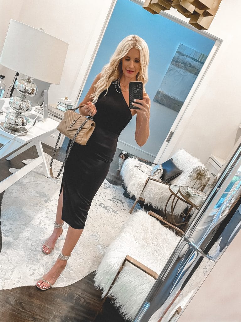 Dallas blogger wearing a black one-shoulder top and a skirt and heels for date night