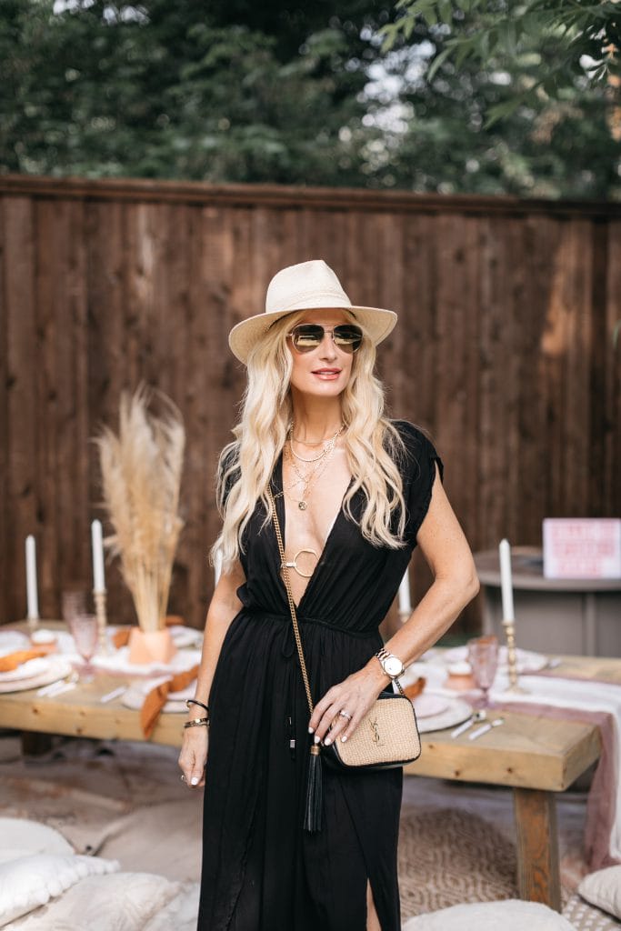 Dallas fashion blogger wearing a straw beach hat and a black swimsuit cover-up