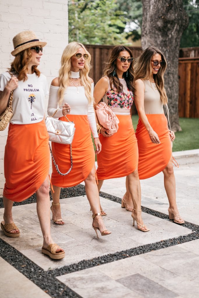 Dallas style bloggers wearing an orange midi skirt styled 4 ways for summer