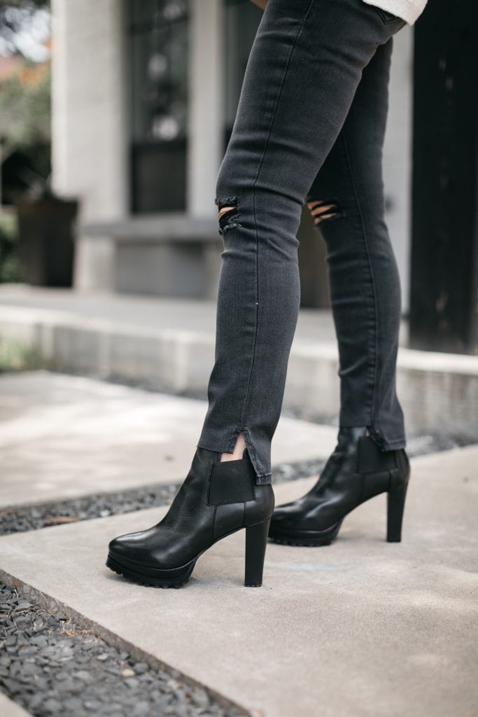 Dallas bloger wearing black ripped denim and booties from the NSALE