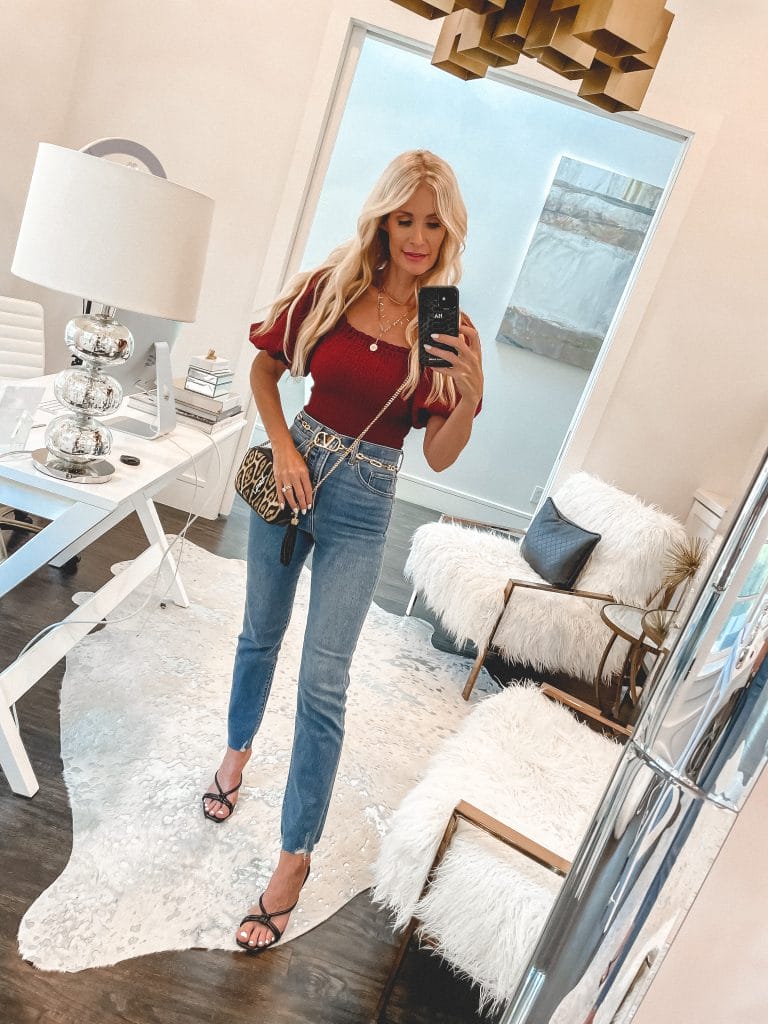 So Heather Blog wearing a ruse colored puff-sleeve top and high waist denim