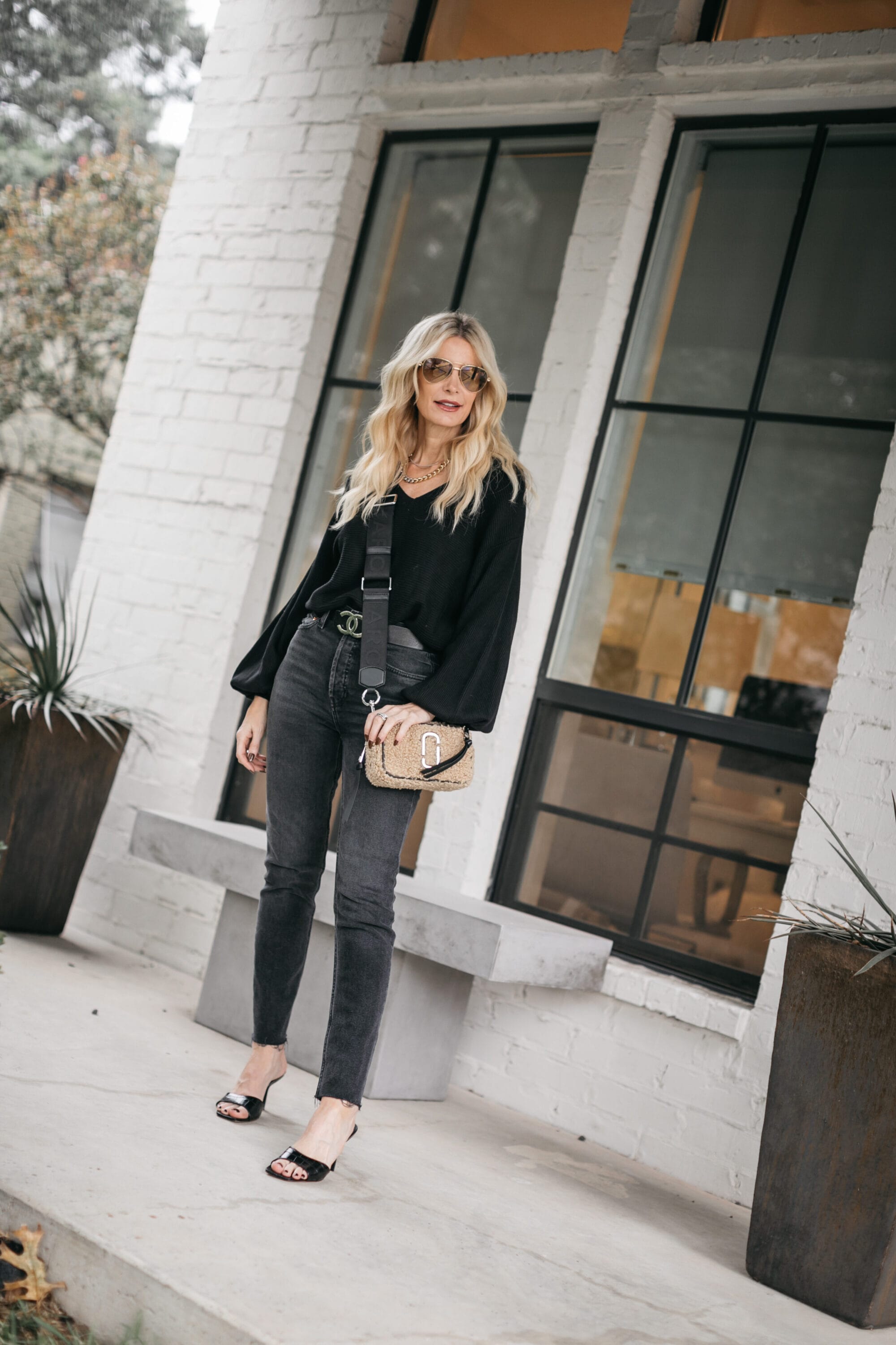 Fashion blogger wearing a black balloon sleeve sweater