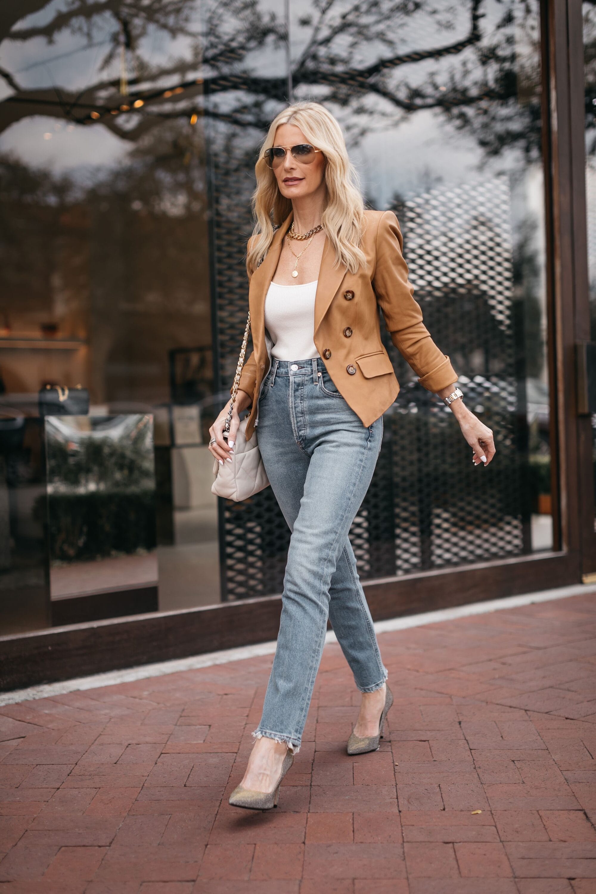 Dallas fashion blogger over 40 wearing camel faux leather jacket with light wash denim and white bodysuit