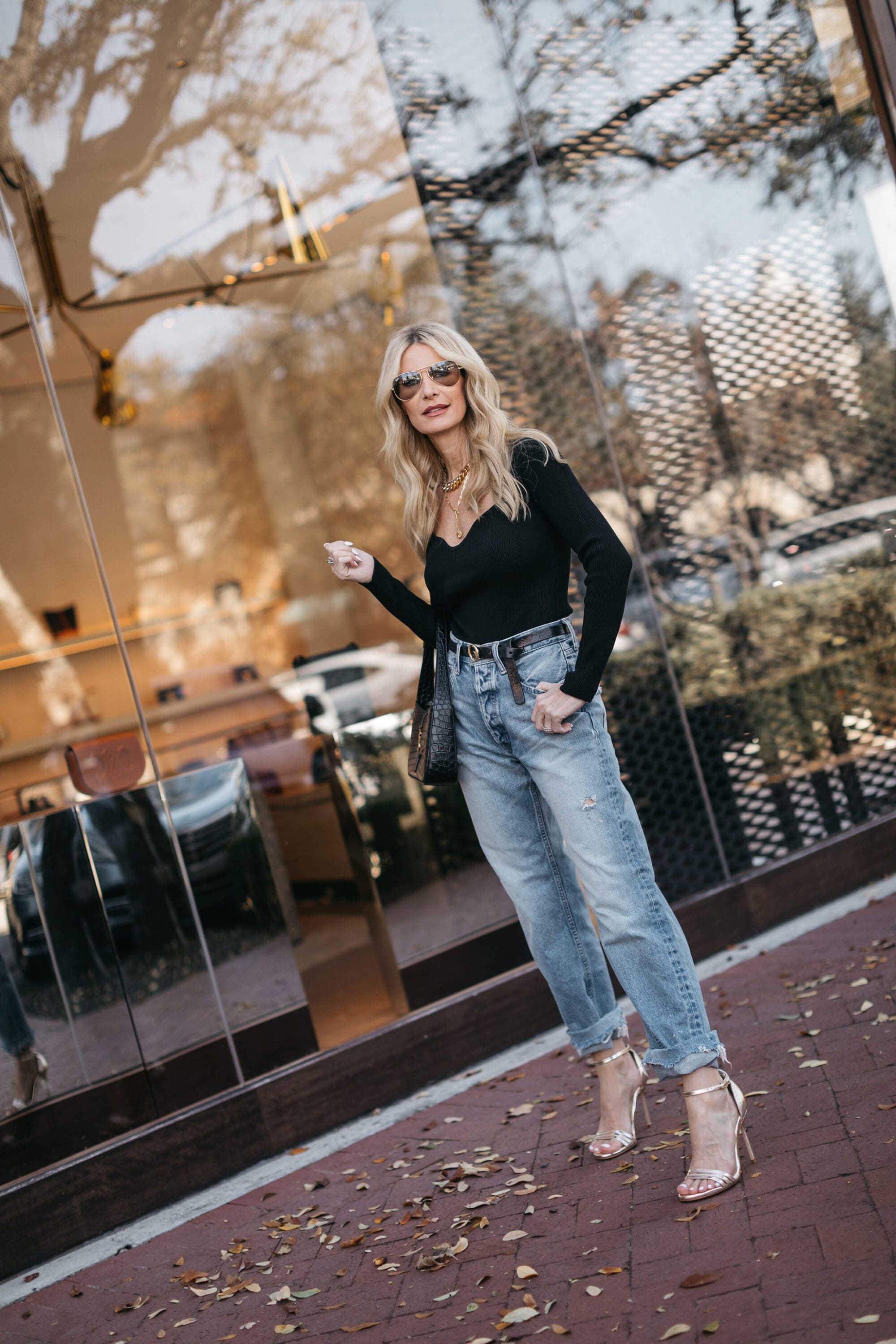 Dallas fashion blogger over 40 wearing solid black shirt and straight leg denim