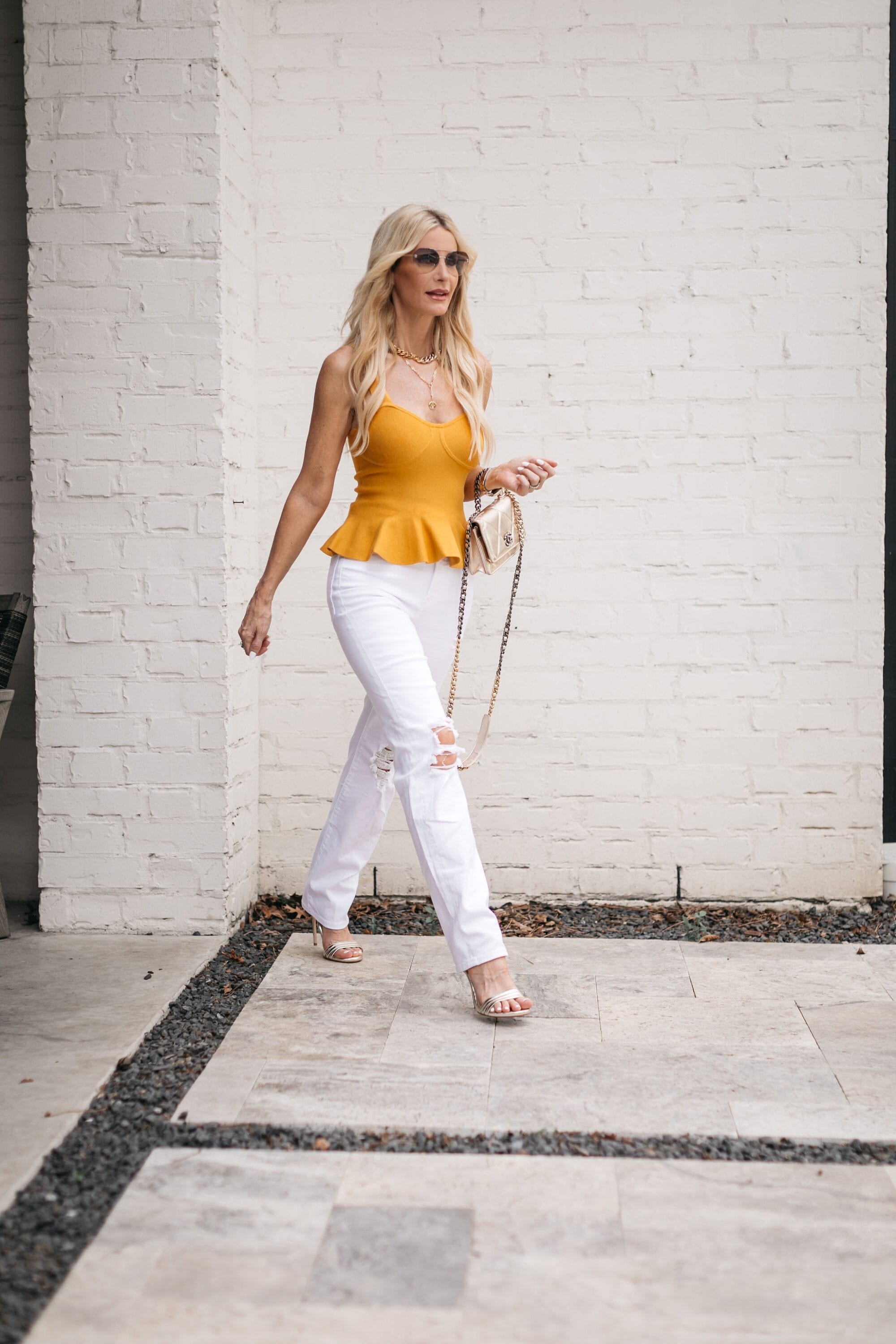 woman over 40 wearing white straight leg jeans