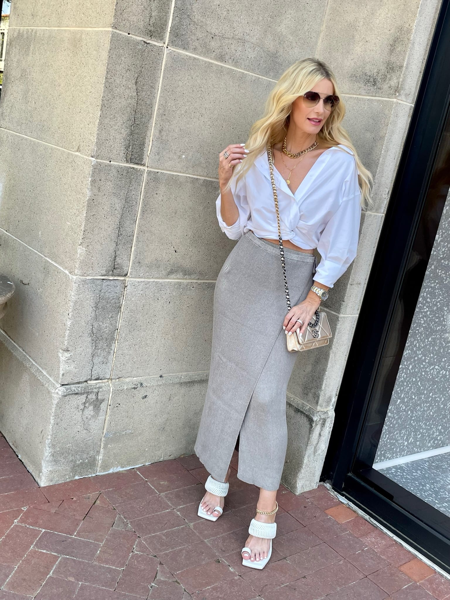 Dallas fashion blogger over 40 wearing white button up top with ribbed pencil skirt and white heeled sandals