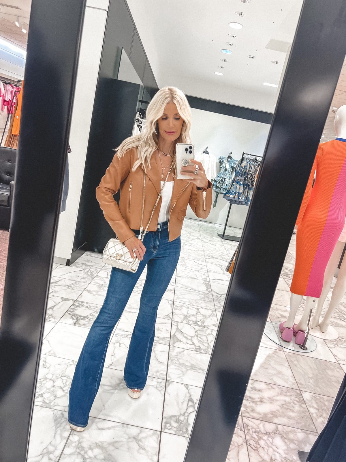 Dallas fashion blogger over 40 weaing under $100 leather jacket and flare jeans as one of Nordstrom Anniversary Outfits 2022