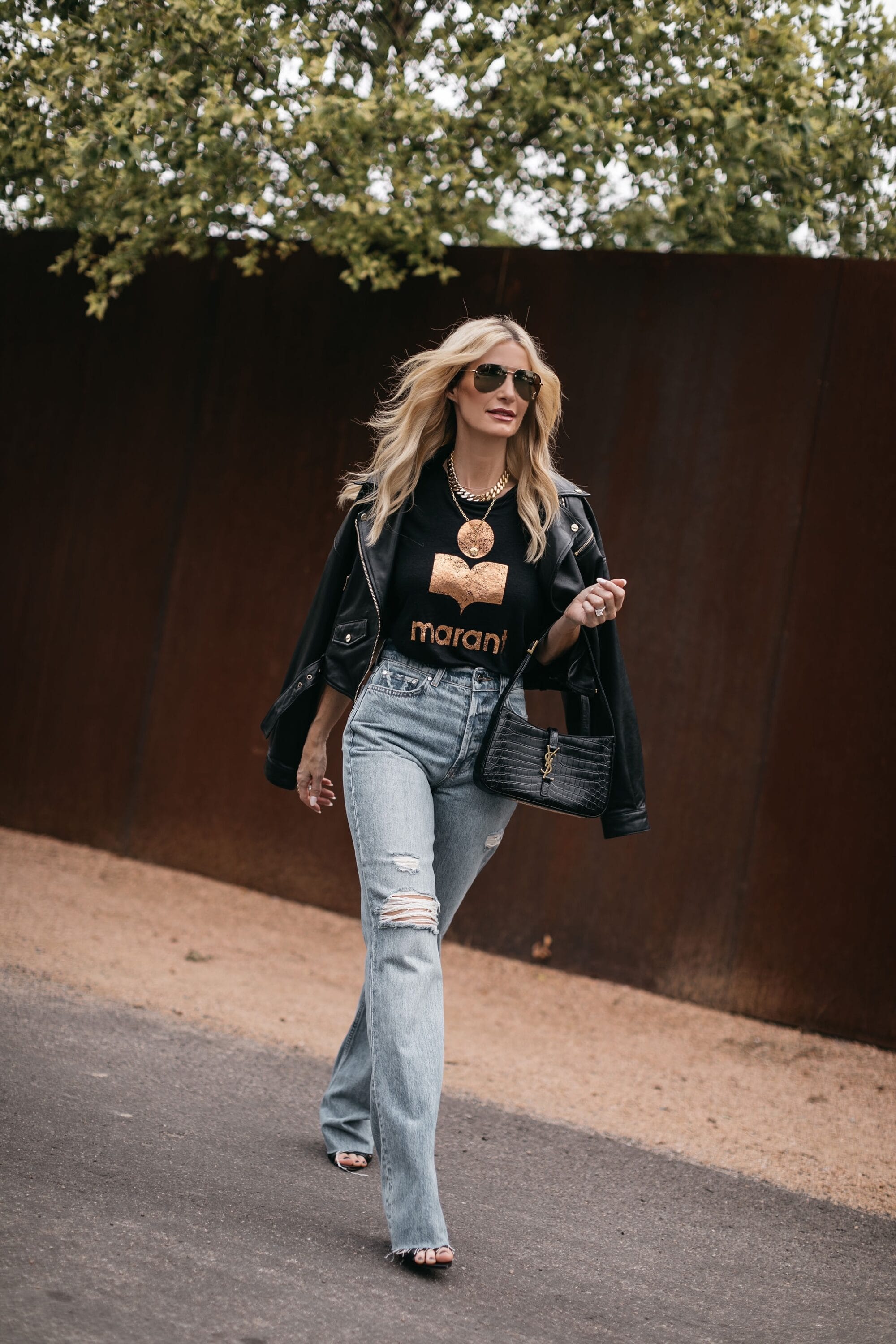 Dallas over 40 fashion influencer wearing puddled hem jeans as one of the top denim trends of 2023.