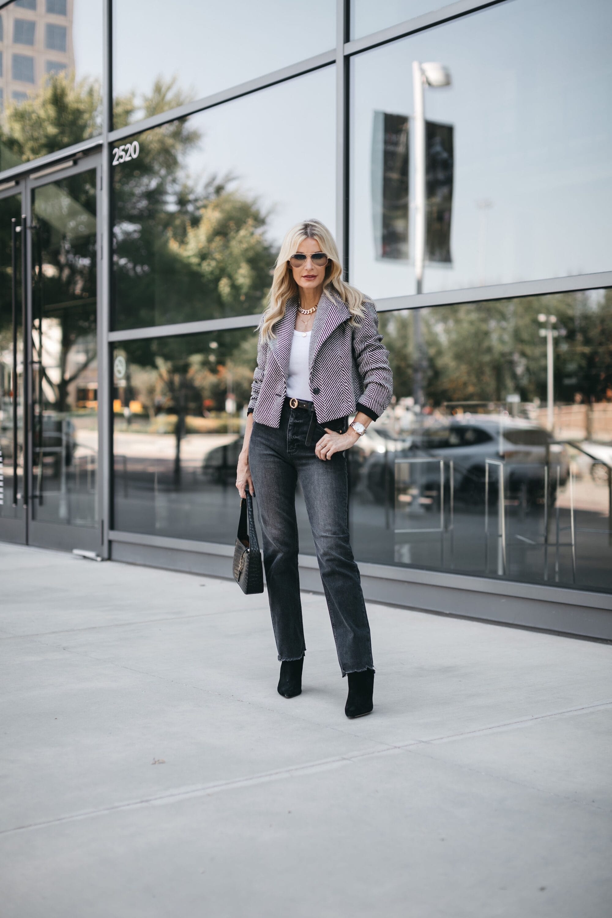 Dallas fashion blogger wearing Veronica Beard ankle booties with stella raw hem jeans and Halogen blazer as one of the best fall boots of 2022