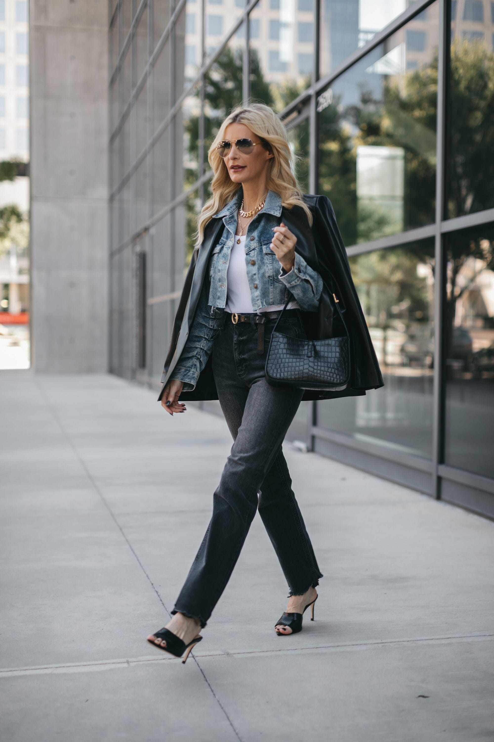 Dallas influencer over 40 wearing straight leg jeans and a white tank as as example of the best base layer for layering fall jackets.