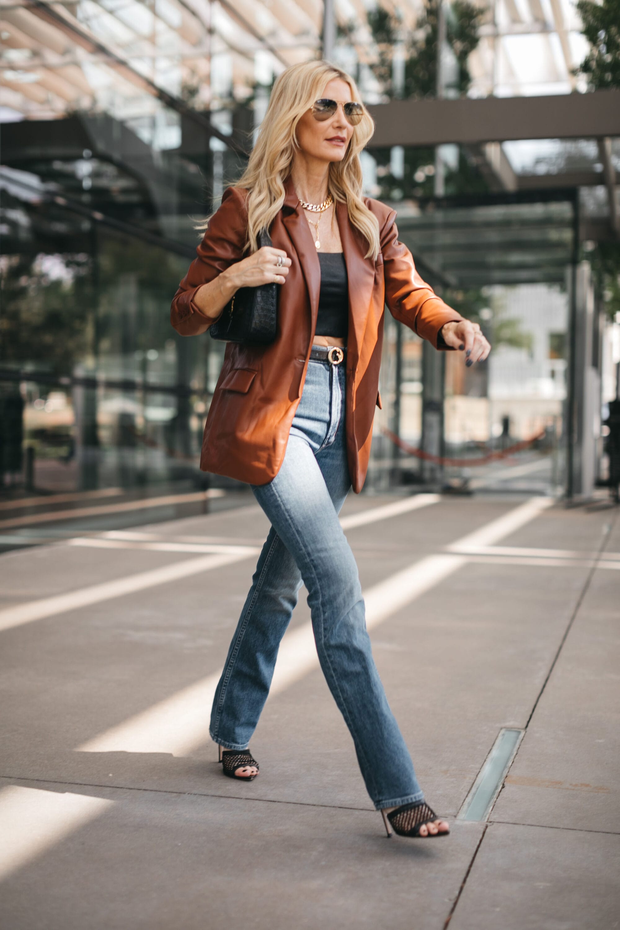 Over 40 fashion blogger wearing oversized faux leather blazer as one of the best winter jackets your wardrobe needs.