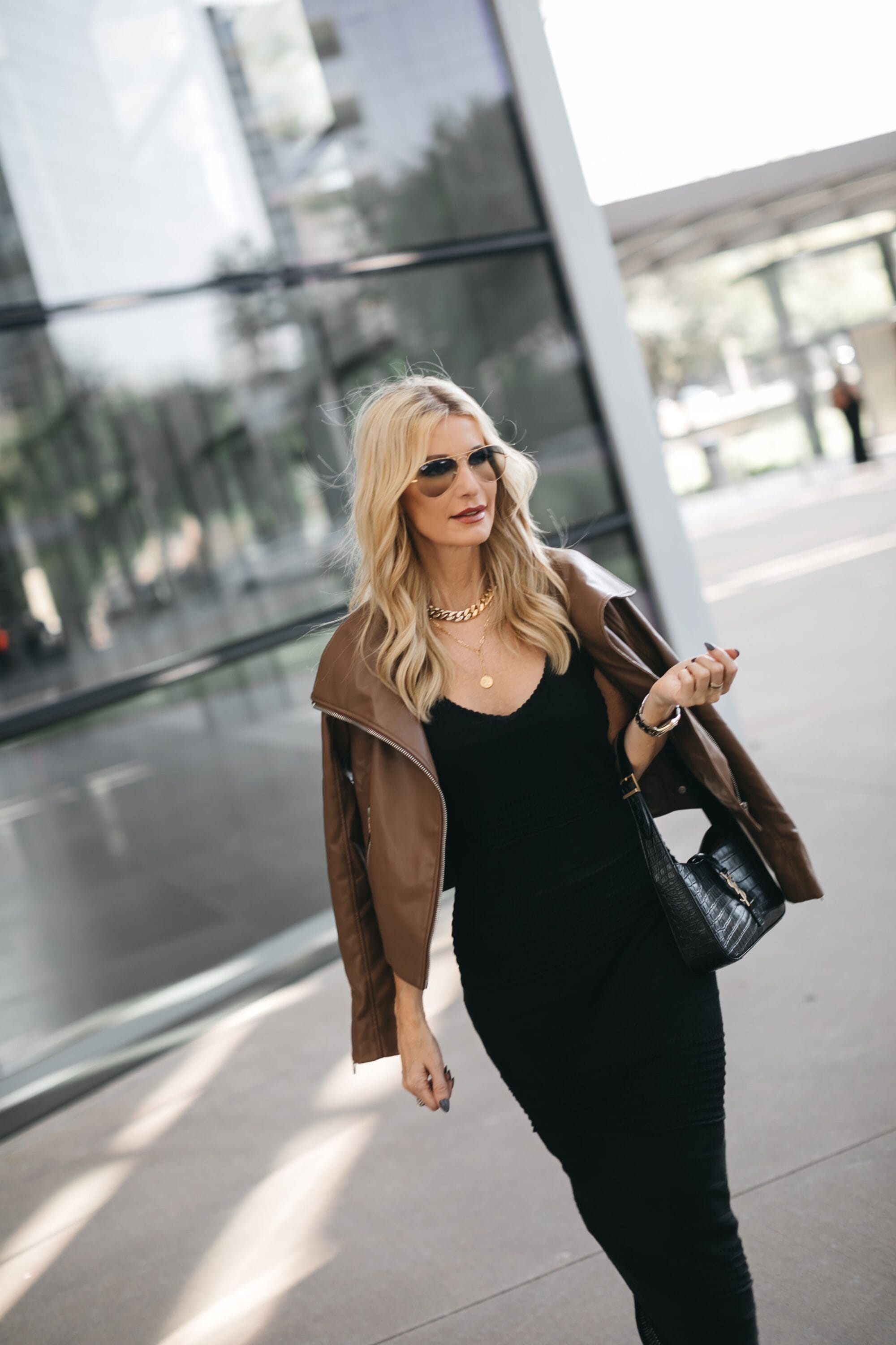 Dallas fashion blogger over 40 wearing faux moto jacket with pointelle sweater dress.