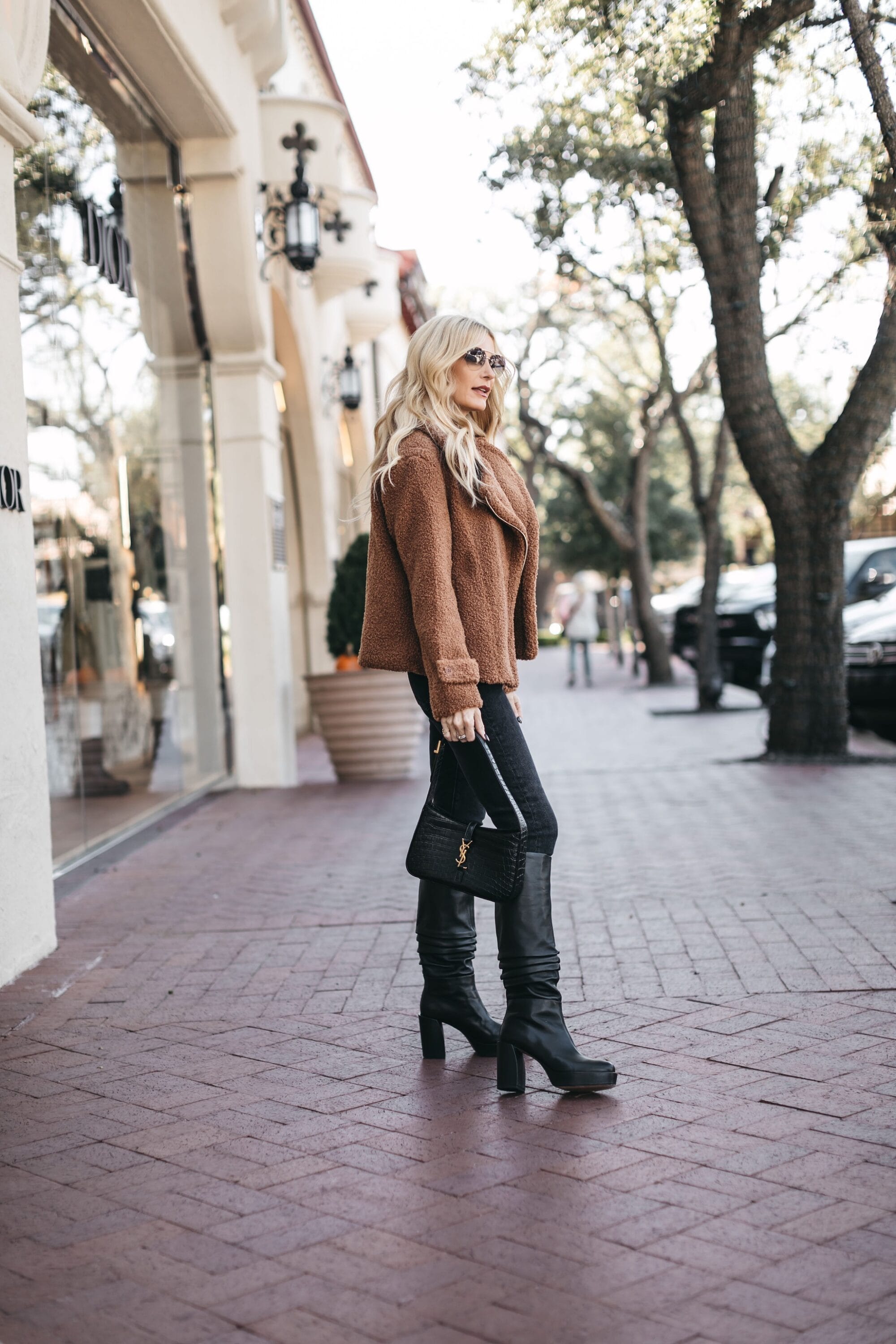 Over 40 fashion influencer showing how to style knee-high boots.