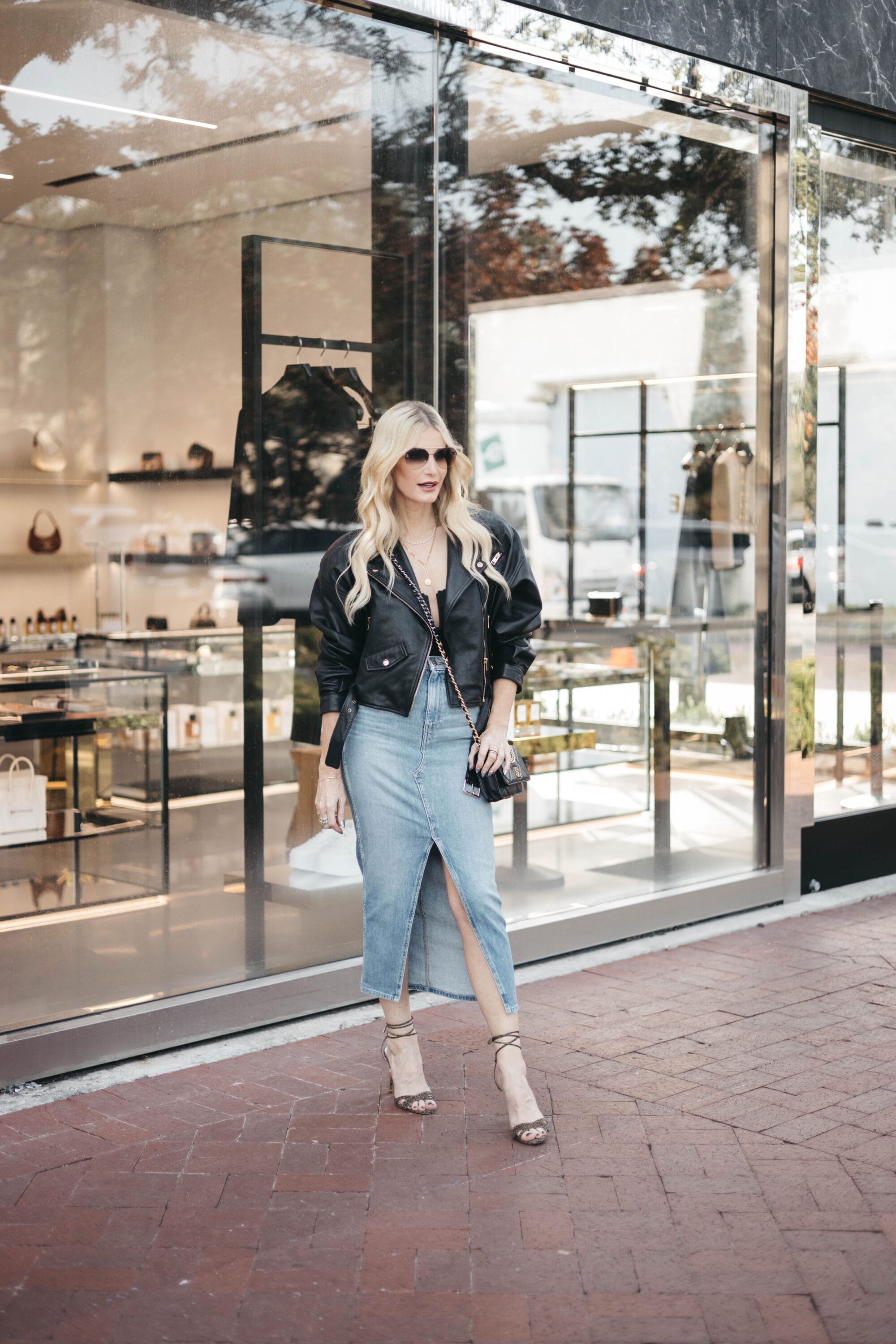 Over 40 Dallas fashion stylist wearing black leather jacket with denim midi skirt as 2 of the top 10 items part of the Saks friends and family sale.