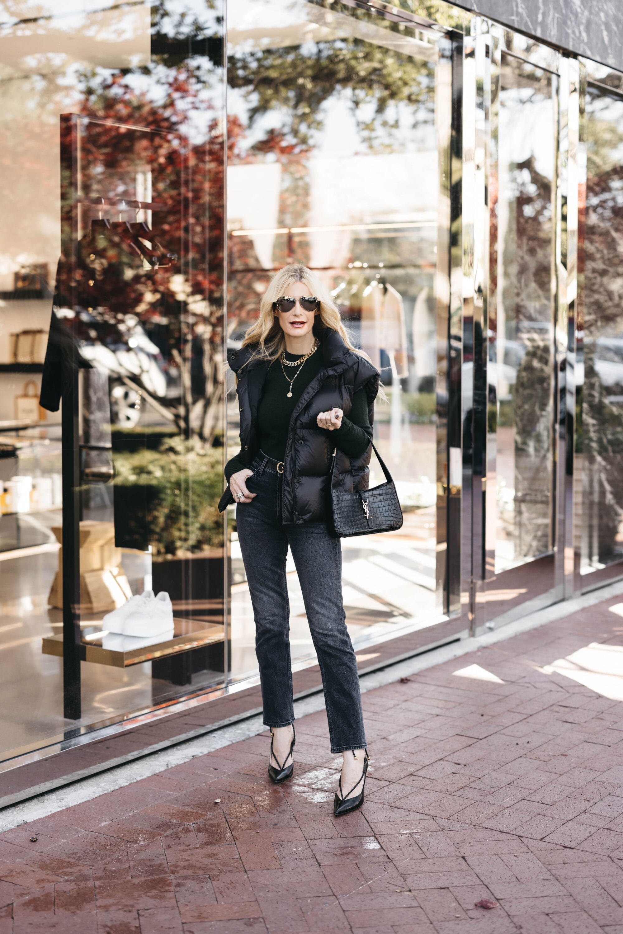 Dallas fashion blogger over 40 wearing black puffer vest as one of the the best winter jackets your wardrobe needs.