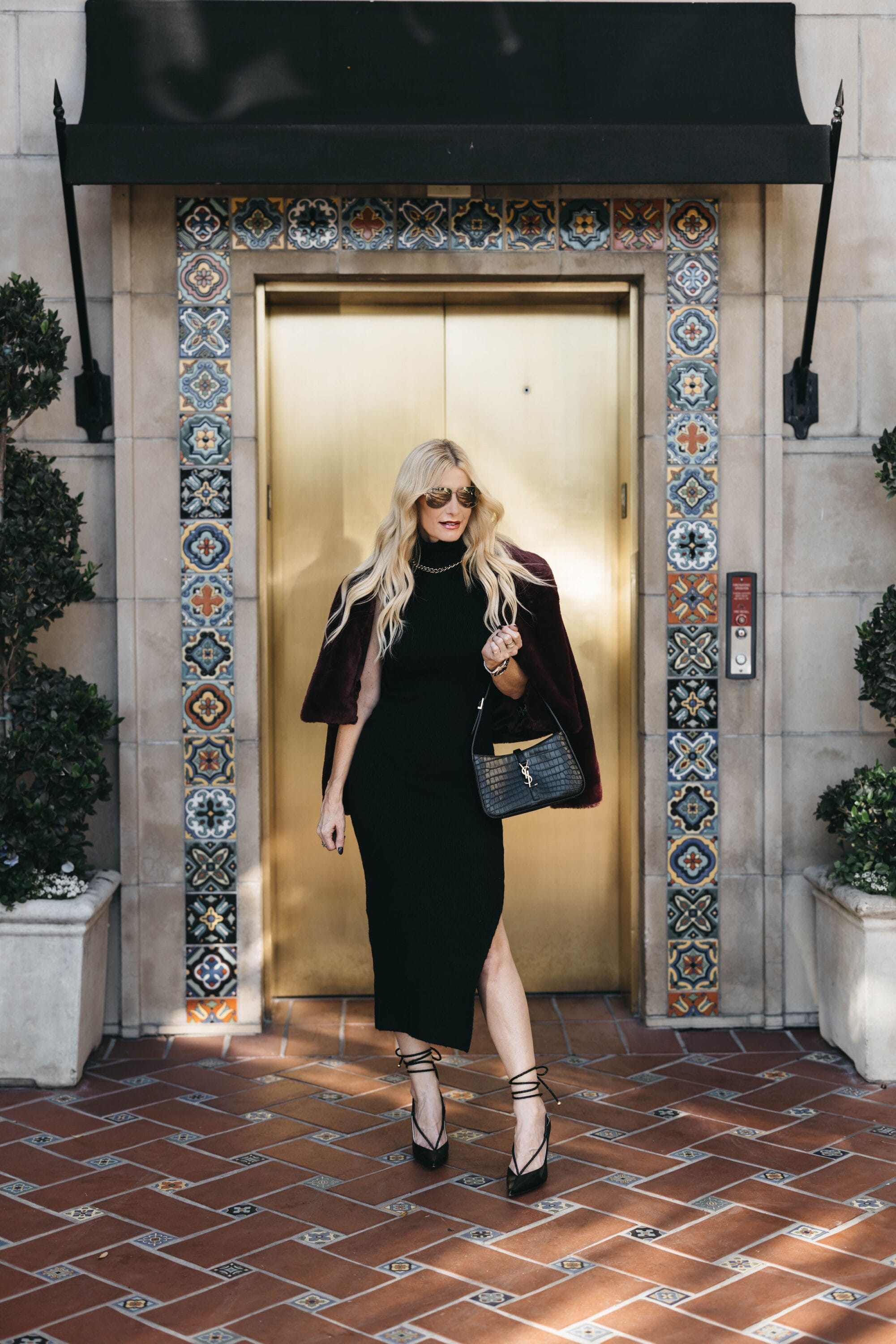 Over 40 fashion influencer wearing a tasetfully sexy winter date night look.