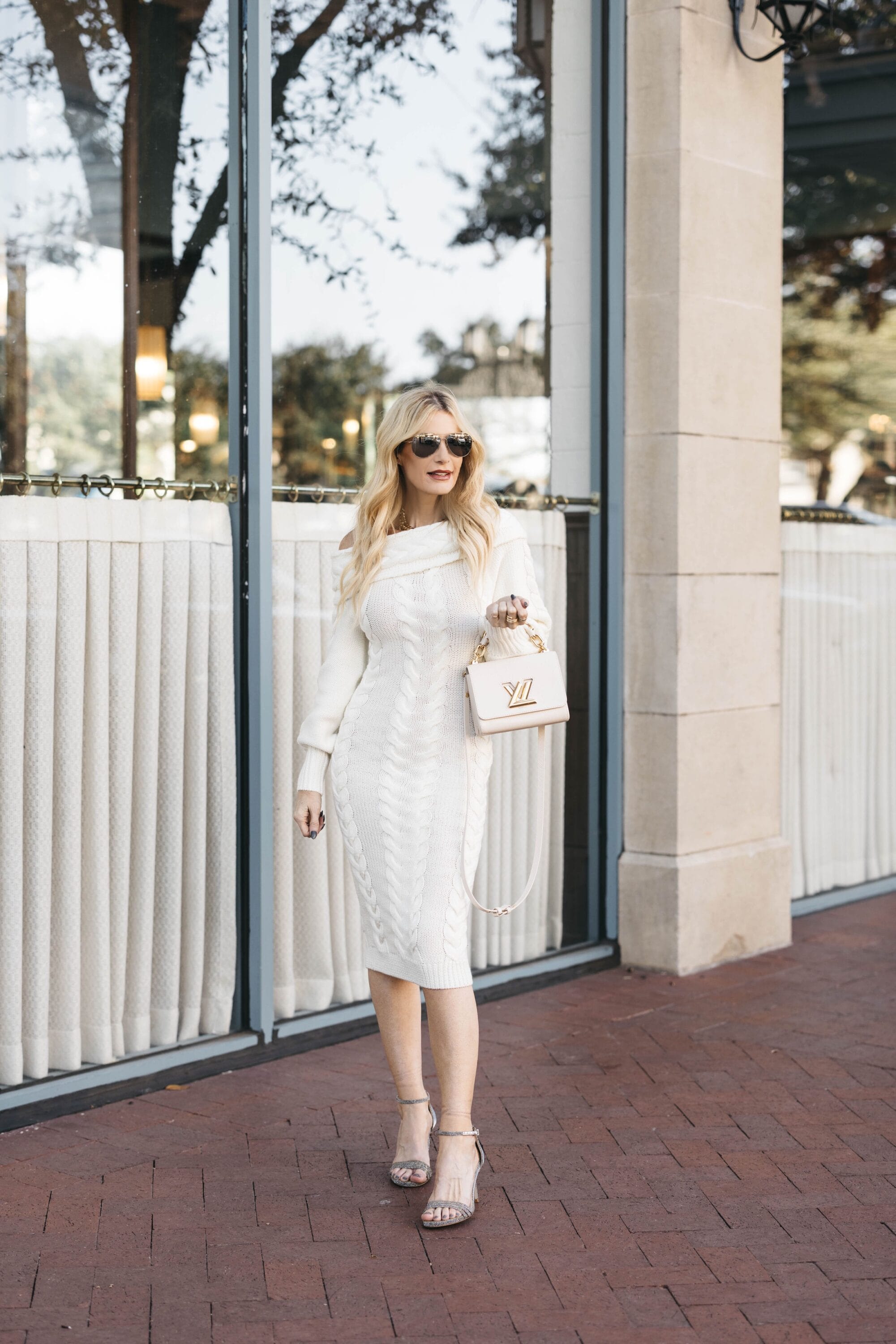 Over 40 fashion influencer wearing white sweater dress with sarah flint heels as on of 5 examples of how to wear winter white.
