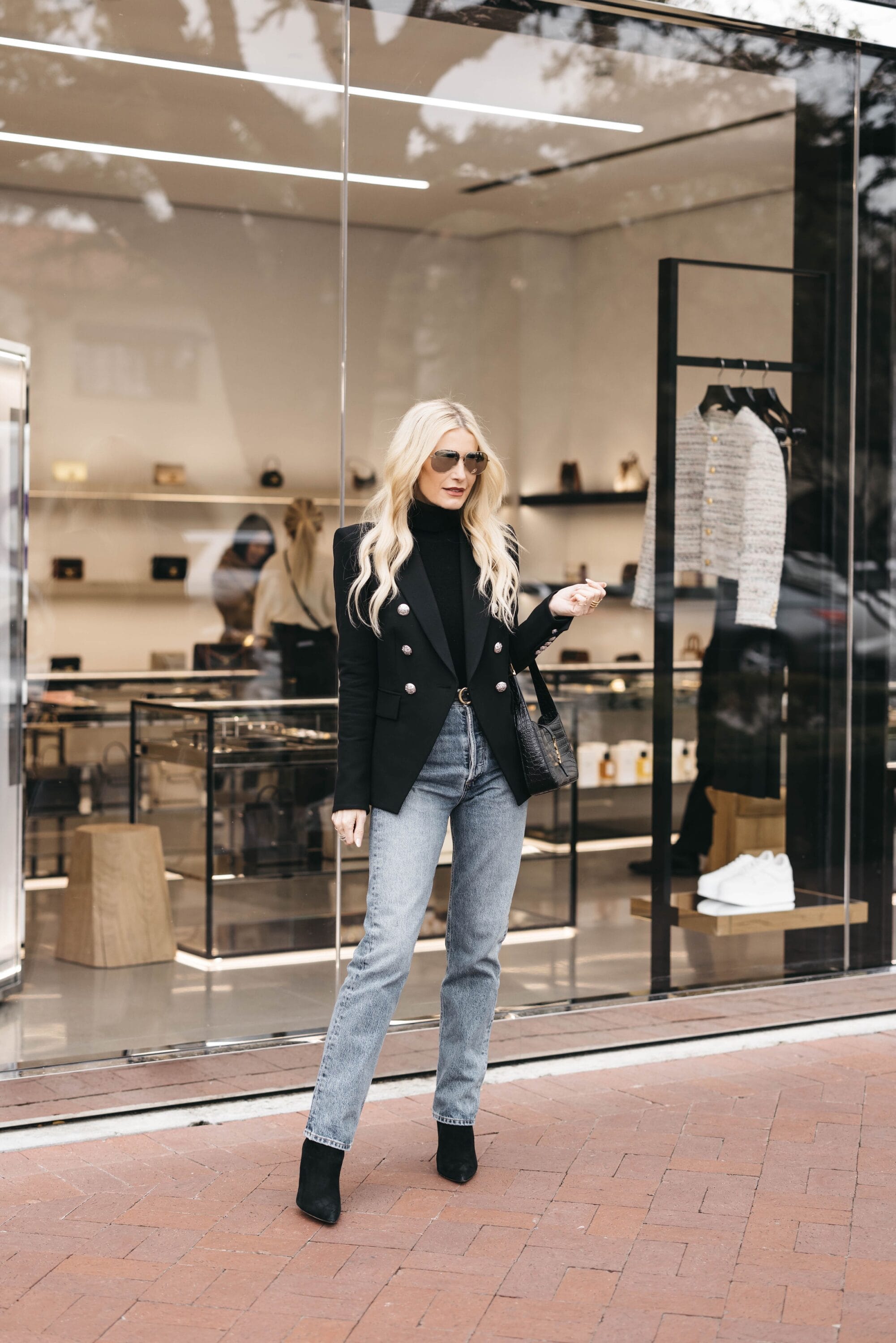 Dallas over 40 fashion blogger wearing black Balmain blazer with agodle 90's pinch waist jeans as one way to stay the wardrobe basics every woman needs.