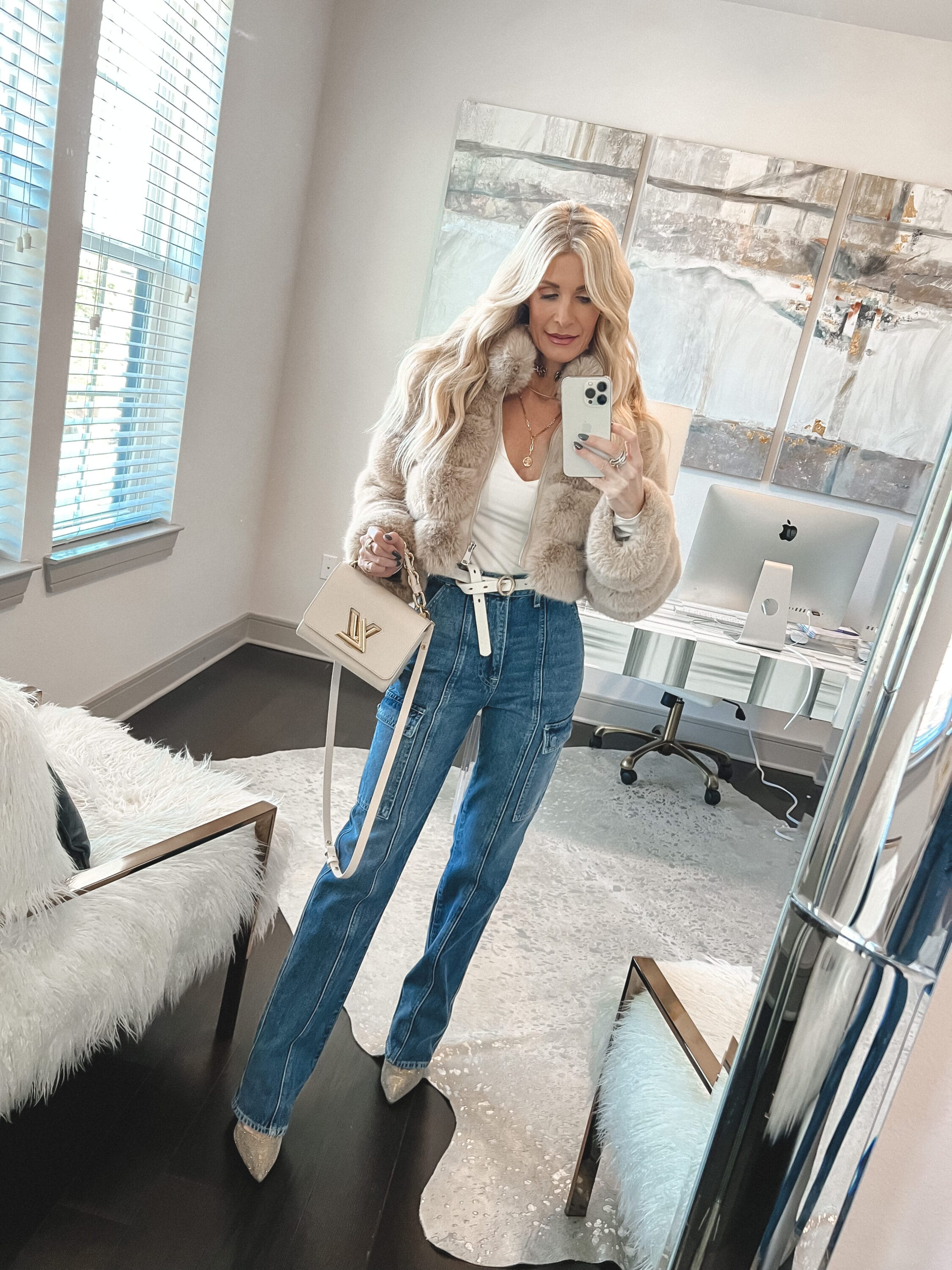 Over 40 fashion blogger from dallas wearing just cargo pants with a fur coat and white bodysuit instead of everything cargo which is a trend to ditch in 2023.