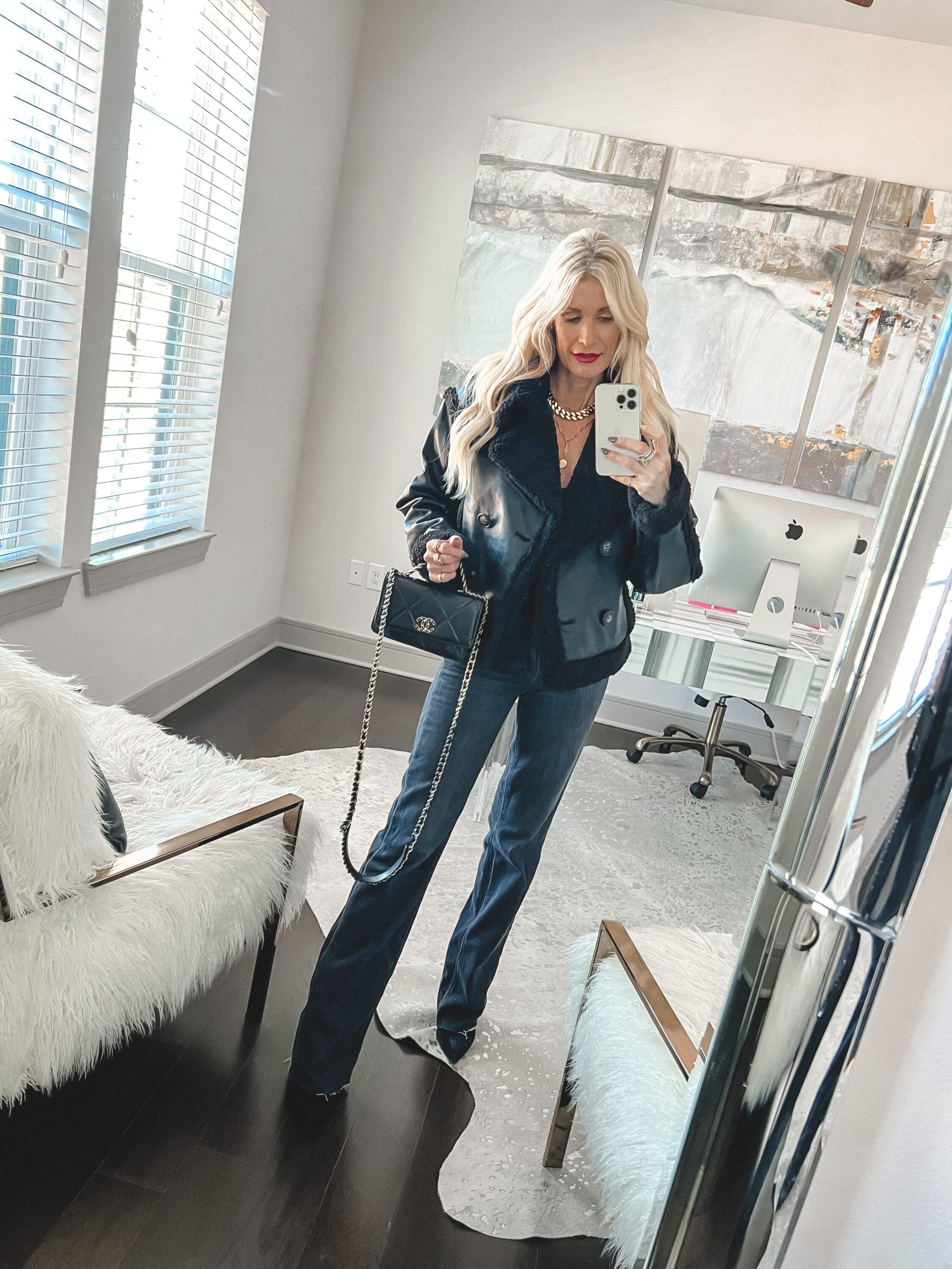 Dallas fashion influencer over 40 wearing faux fur and leather jacket with black vintage jeans as part of her winter coat edit.