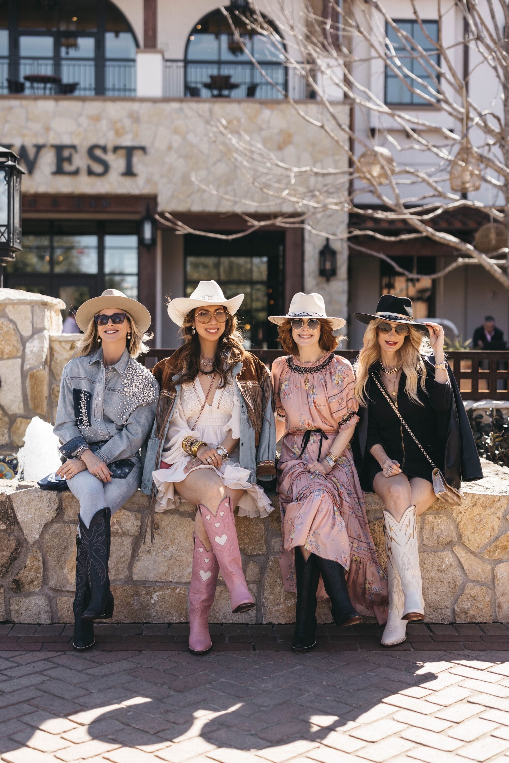 Over 40 fashion bloggers wearing western best in front of Hotel Drover.