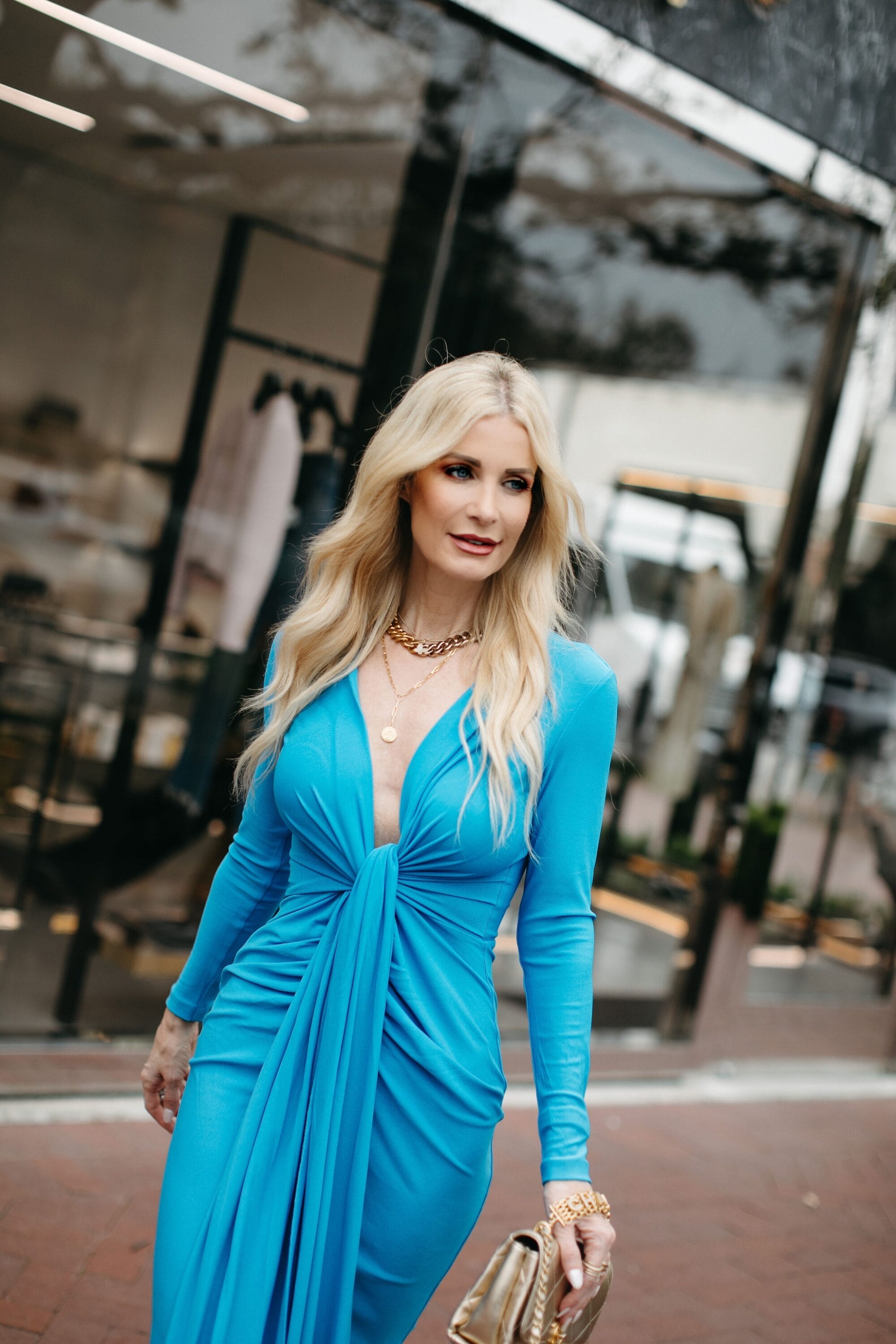 Dallas over 40 fashion icon wearing midi dress in AZURE blue as one of seven resort wear looks for 2023.