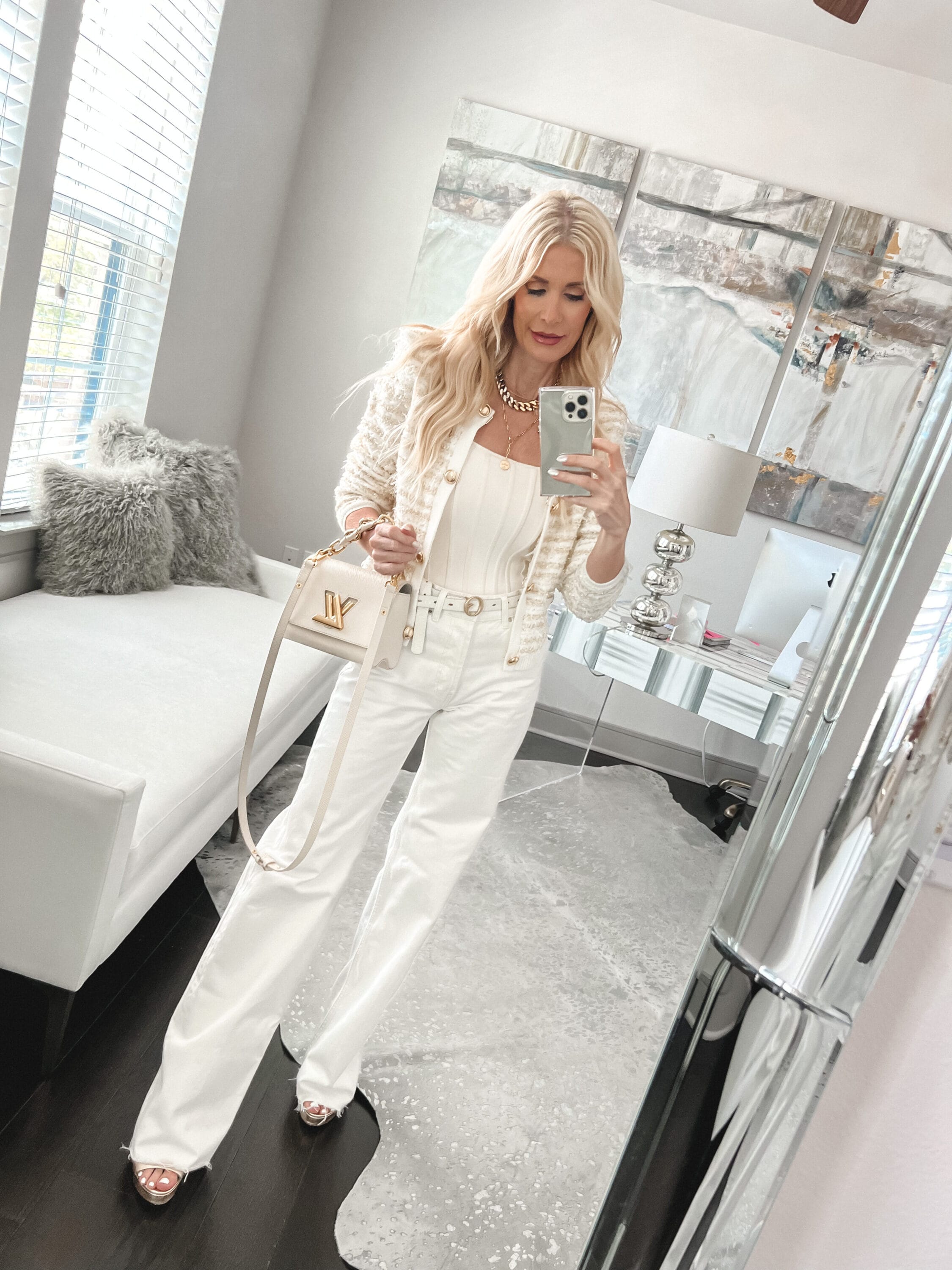 Dallas fashion influencer wearing ivory denim with a Chanel inspired sweater jacket.
