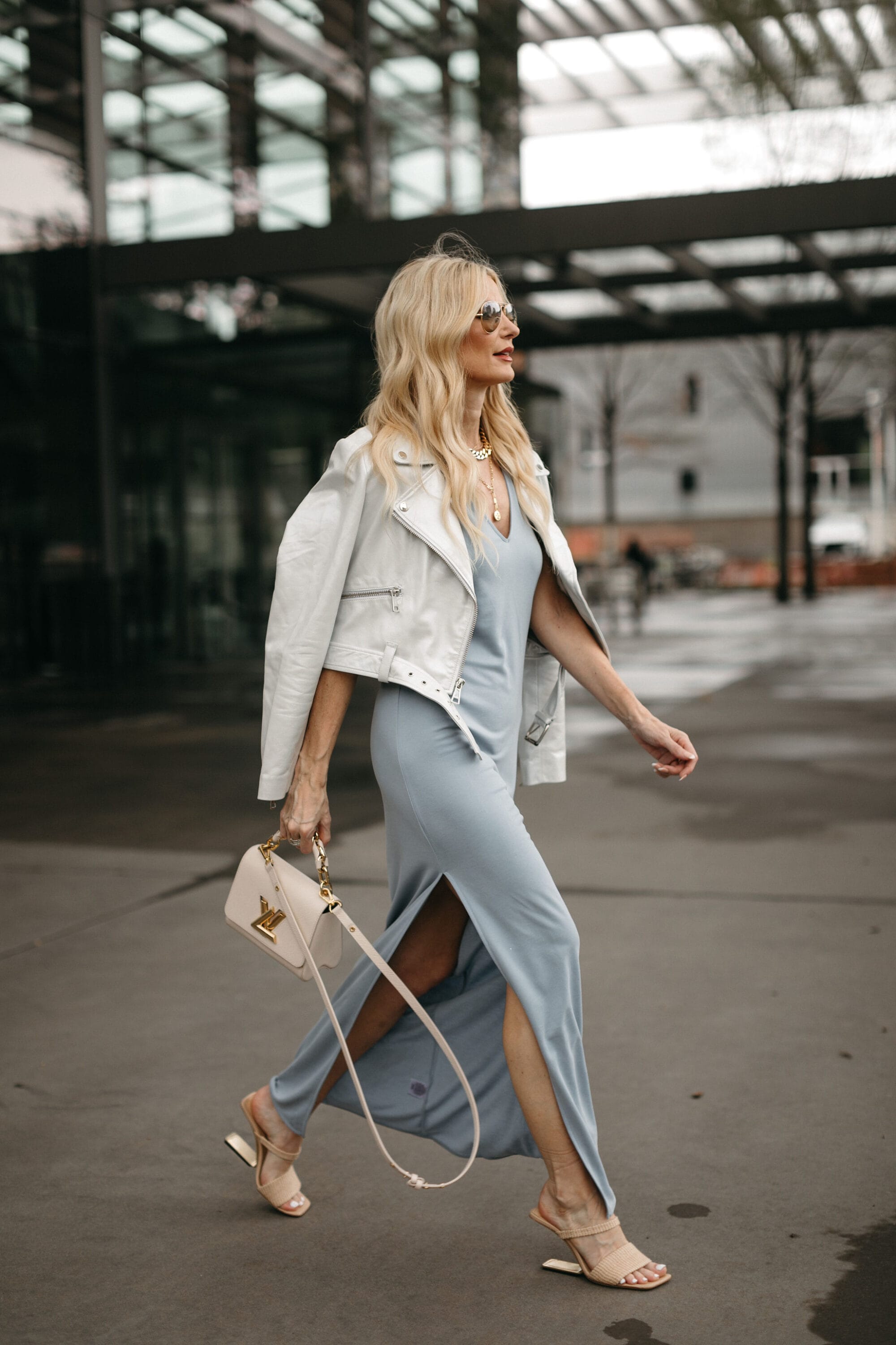 Over 40 fashion influencer wearing maxi dress with cropped blazer for spring 2023.