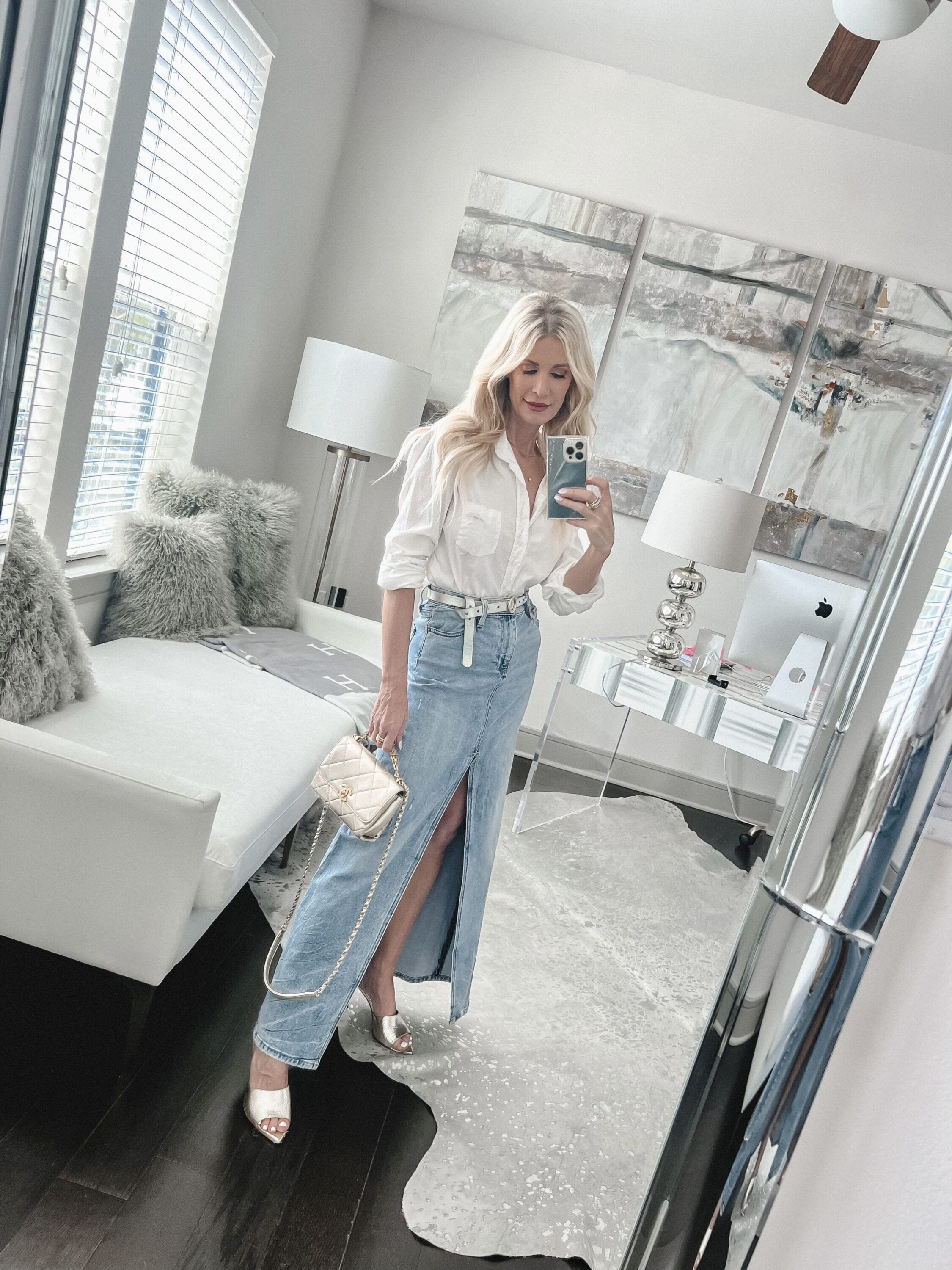 Over 40 fashion influencer from Dallas wearing the top spring denim trends of 2023 in the form of a denim midi skirt.