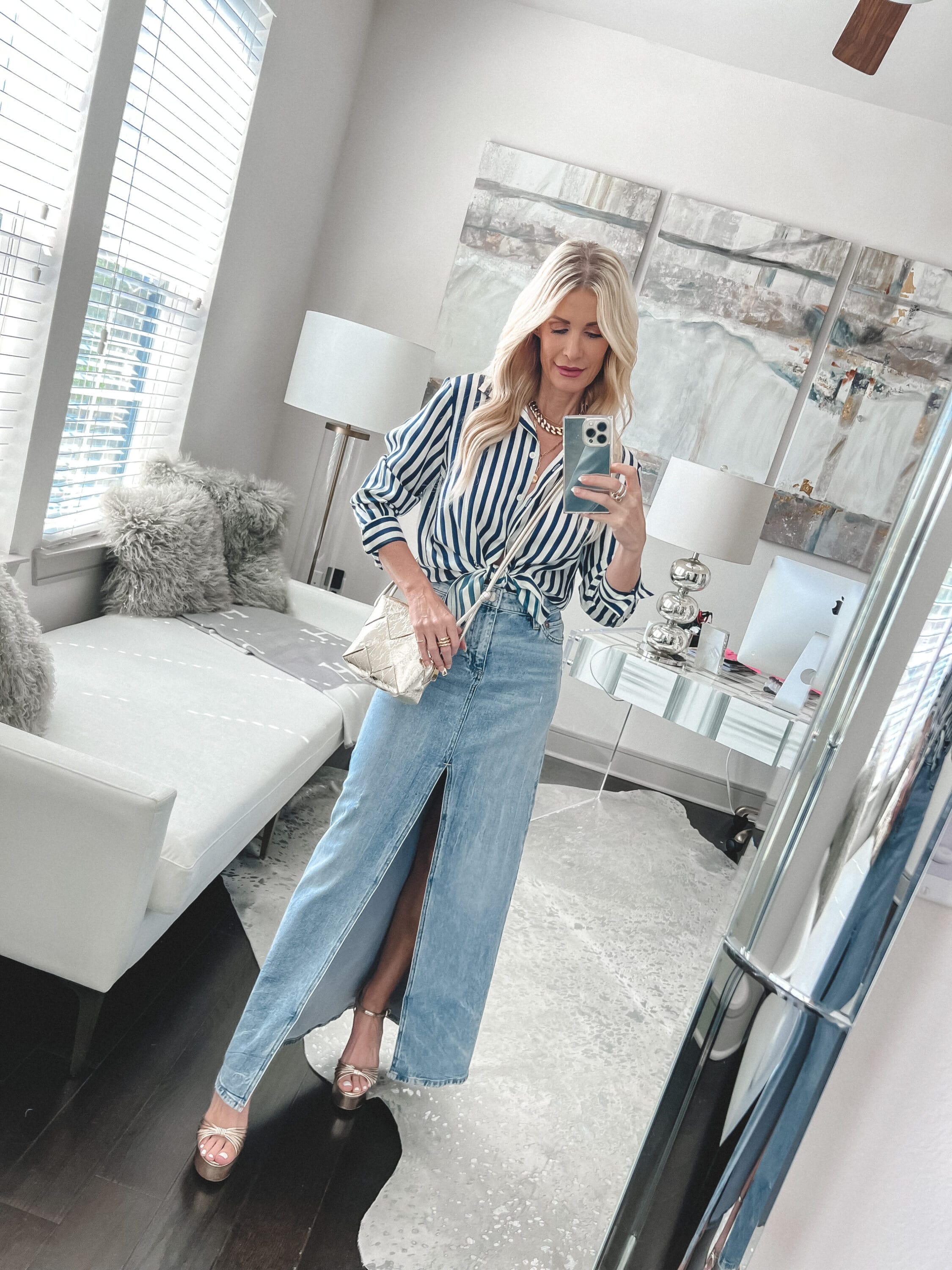 Over 40 fashion influencer showing how to style denim midi skirt with a classic button-down shirt.