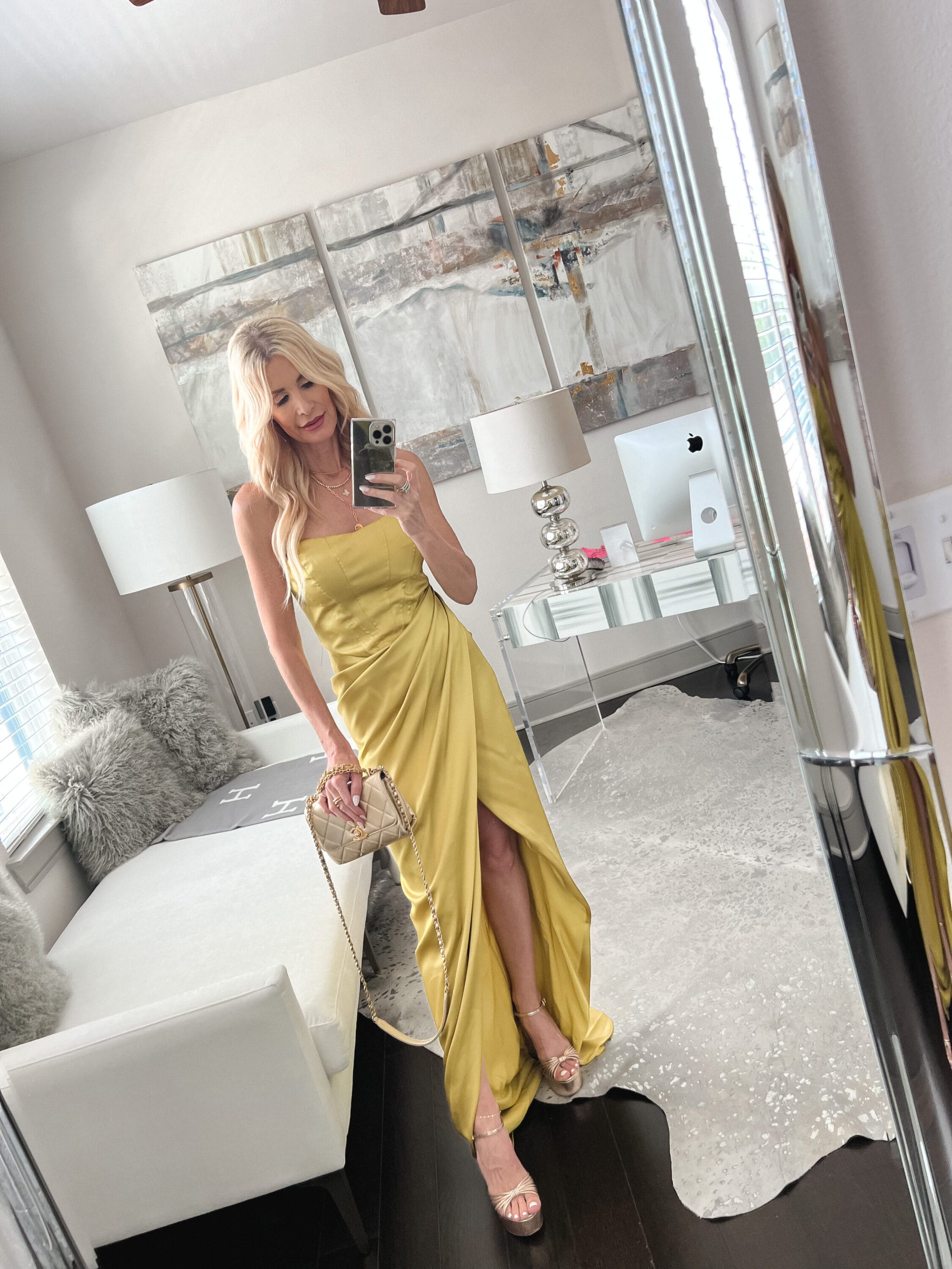 Over 40 fashion blogger wearing a yellow maxi dress with gold platforms as one of 7 summer dresses for 7 occasions.