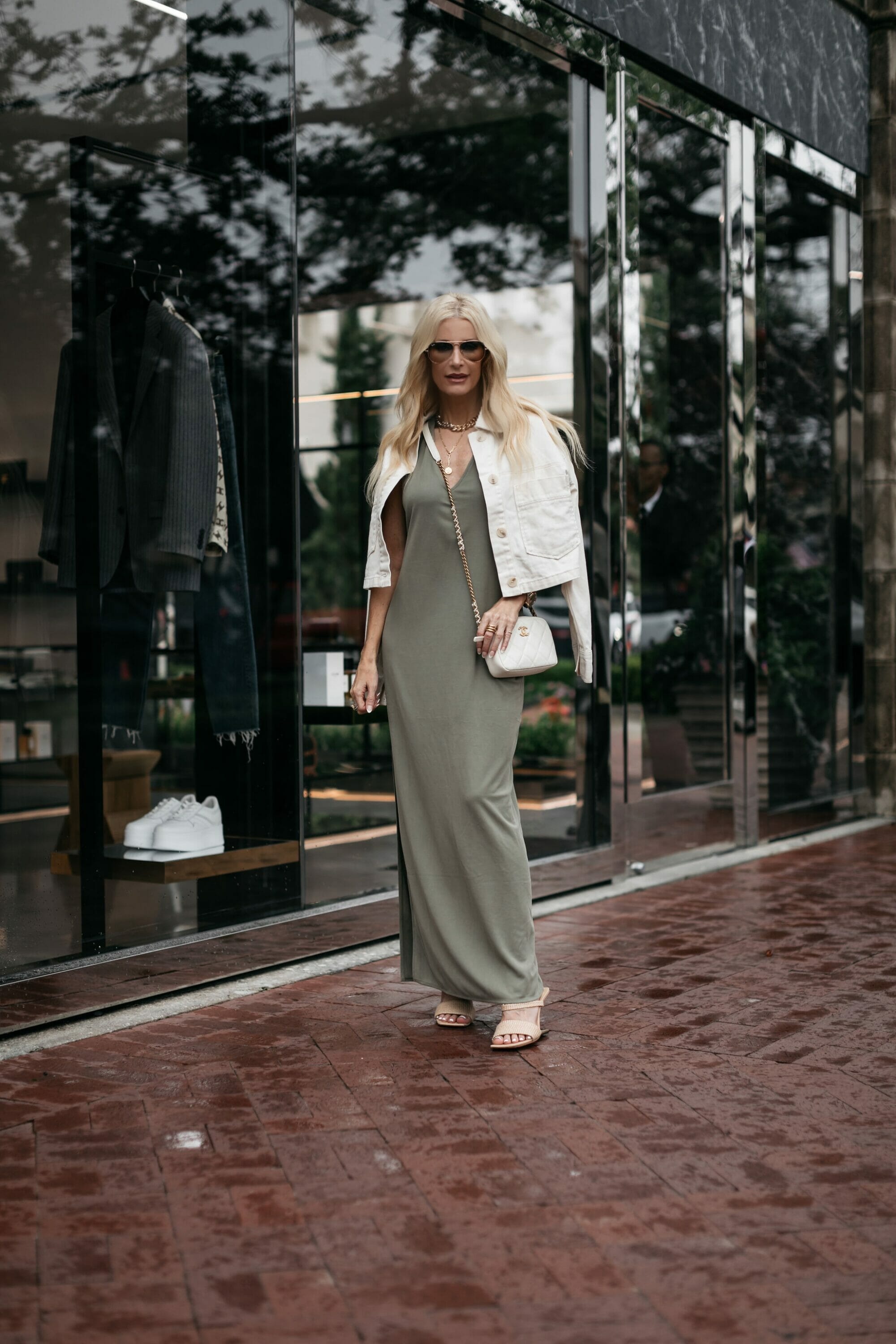Dallas fashion stylist over 40 wearing olive green dress with an ivory jacket and neutral heels as one of 5 expensive looking color combinations.