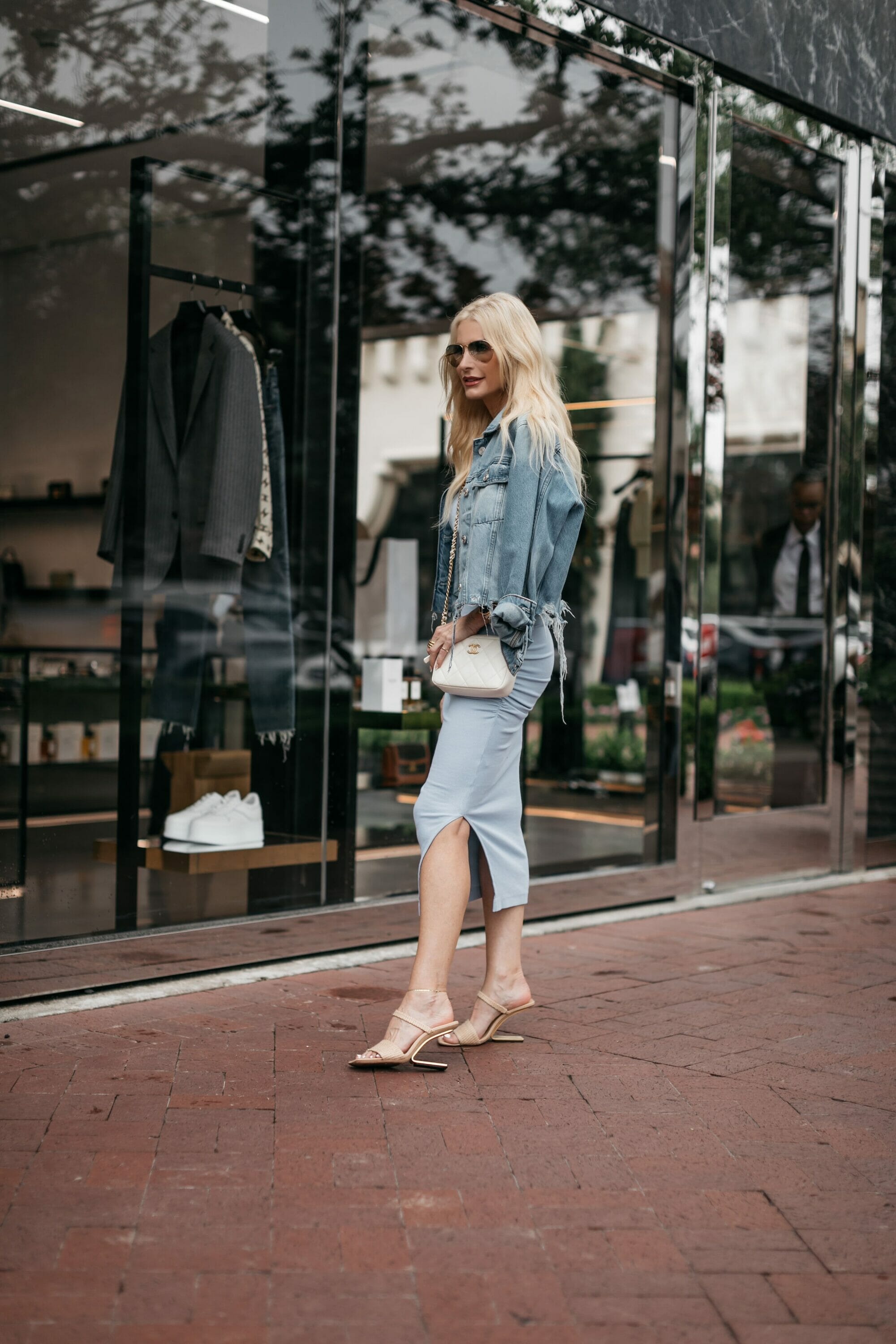 Dallas fashion blogger wearing the best under $100 summer dress from Michael Stars with a distressed denim jacket and neutral heels.
