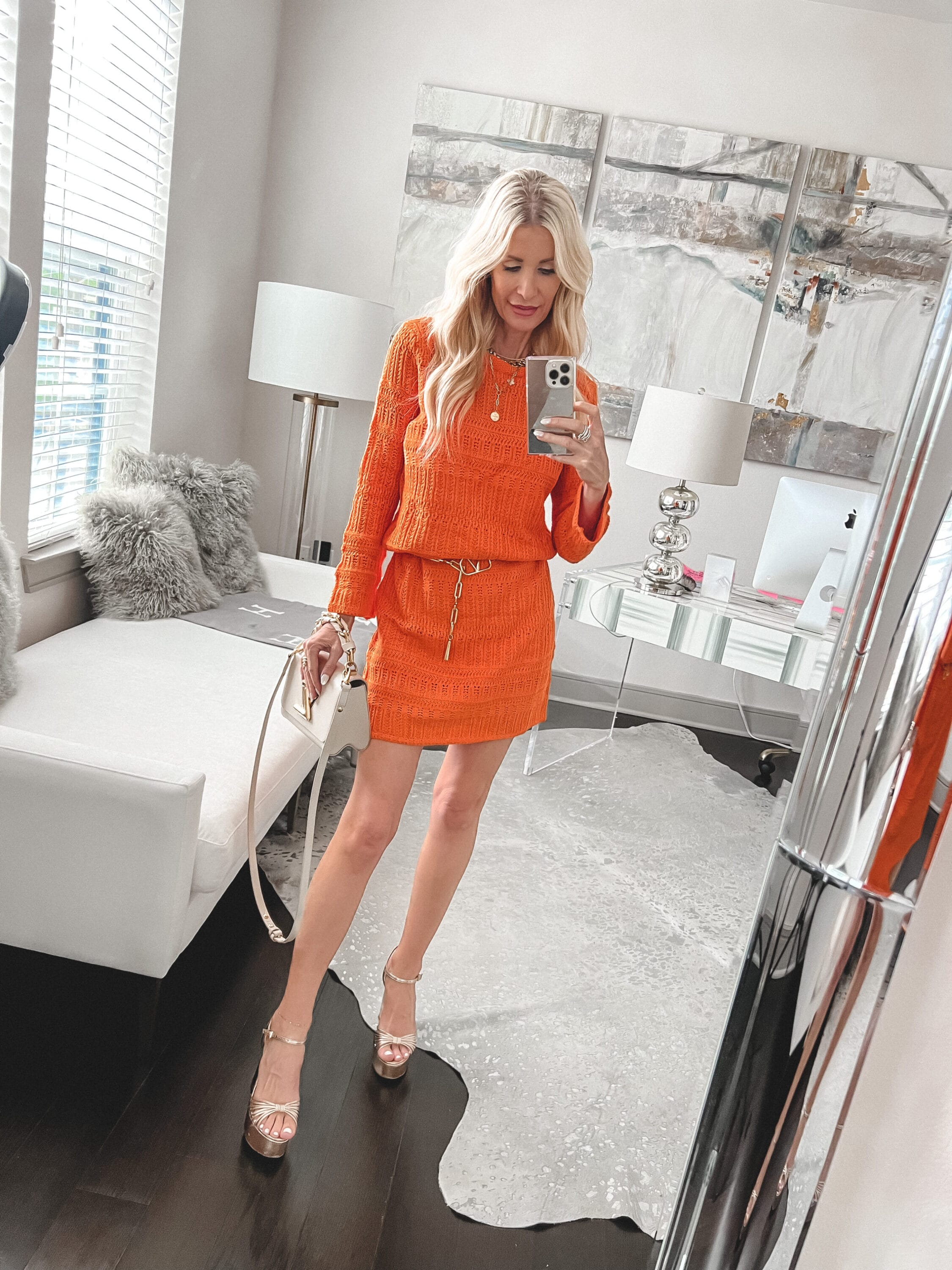 Over 40 Dallas stylist wearing an orange dress with gold platforms as one of the best under $50 summer must-haves.
