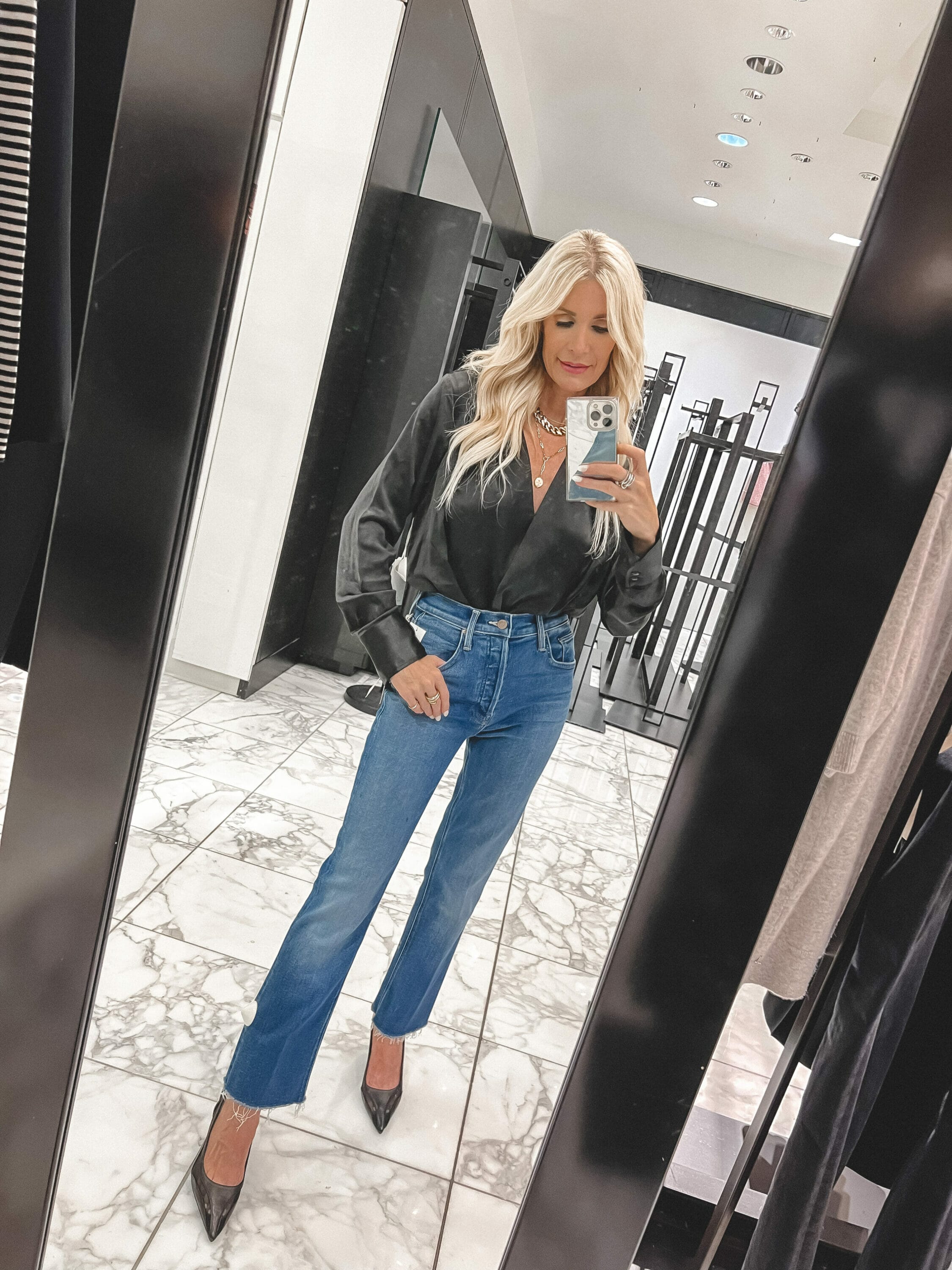 Over 40 fashion stylist wearing Mother jeans with a Good American satin wrap bodysuit as one of the best under $100 pieces from the Nordstrom Anniversary Sale.
