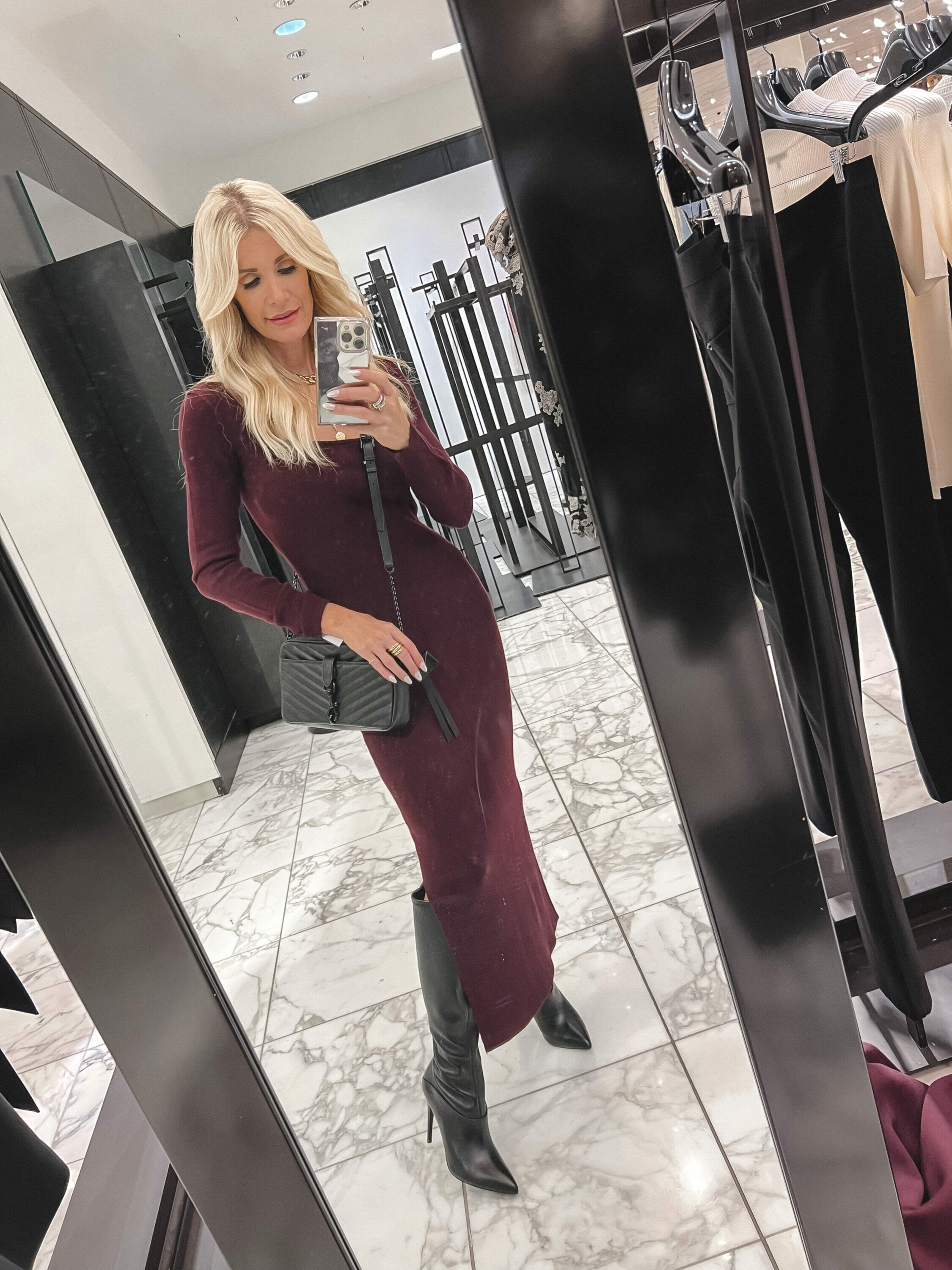Dallas Fashion stylist wearing black knee high boots with a burgundy dress.