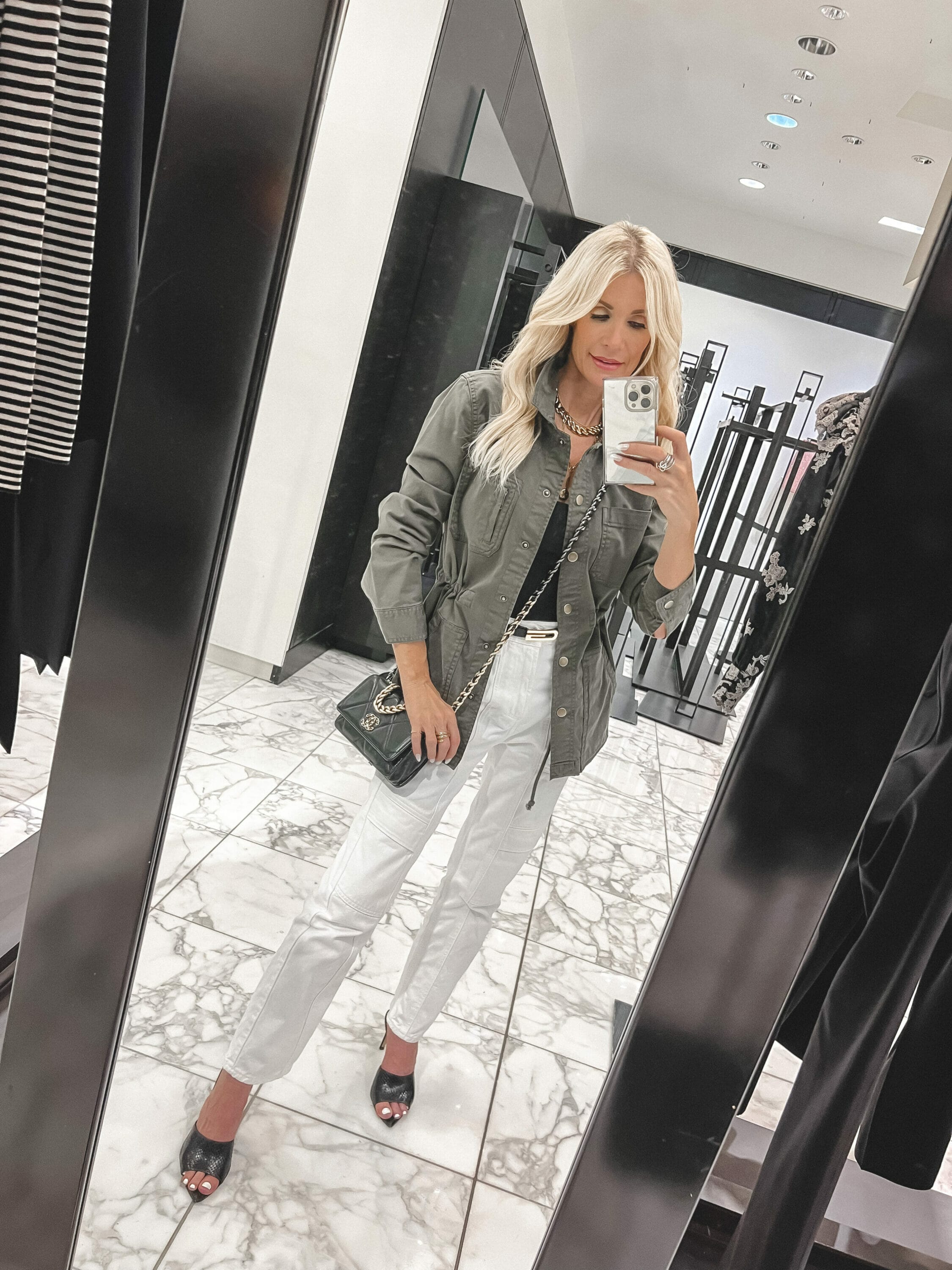 Fashion stylist over 40 wearing sage green utility jacket with white cargo jeans as one of the best under $100 pieces from the Nordstrom Anniversary Sale.
