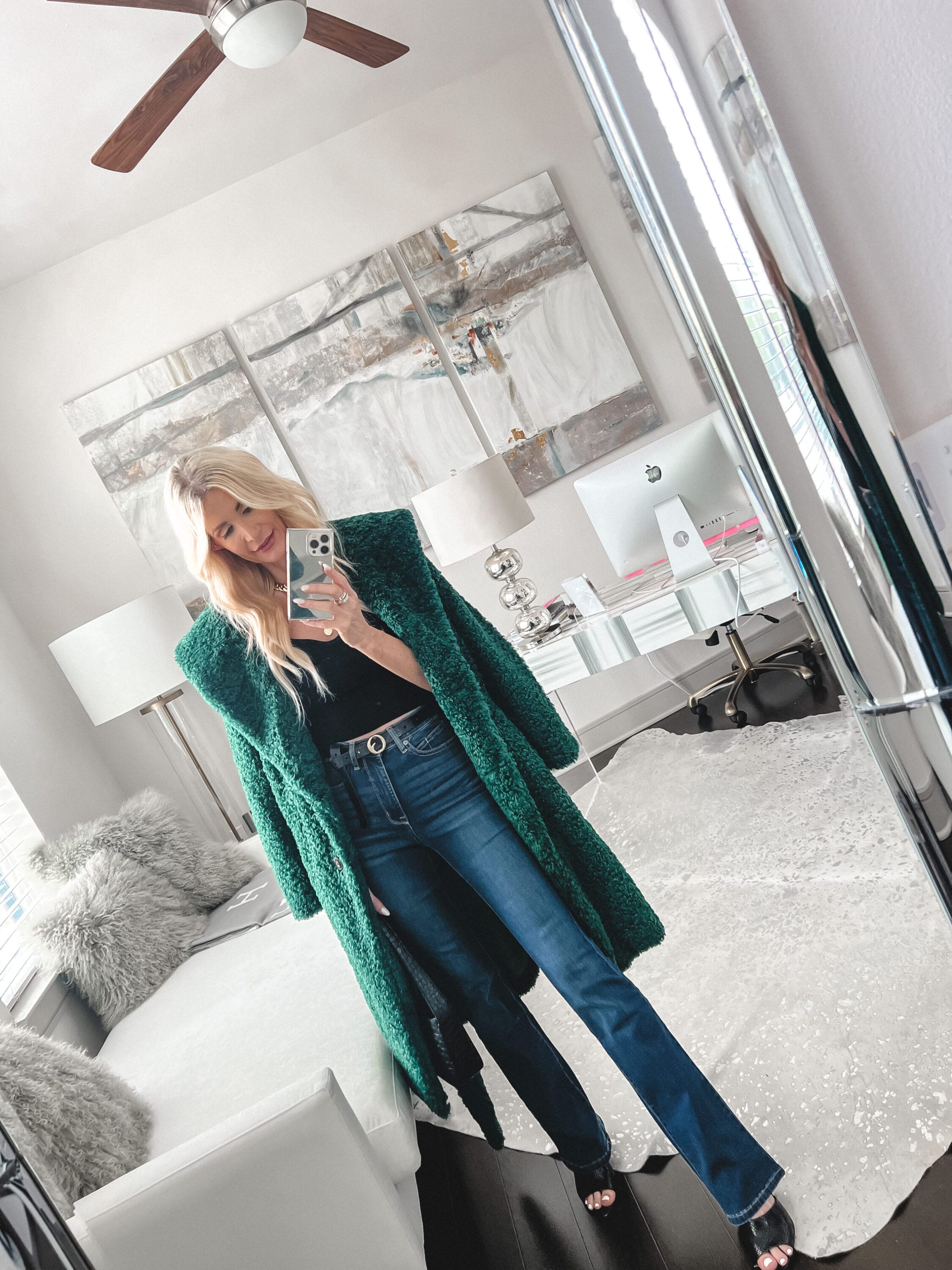 Over 40 fashion stylist wearing green teddy coat over black tank and straight leg jeans as one of the best under $50 pieces your fall wardrobe will love.