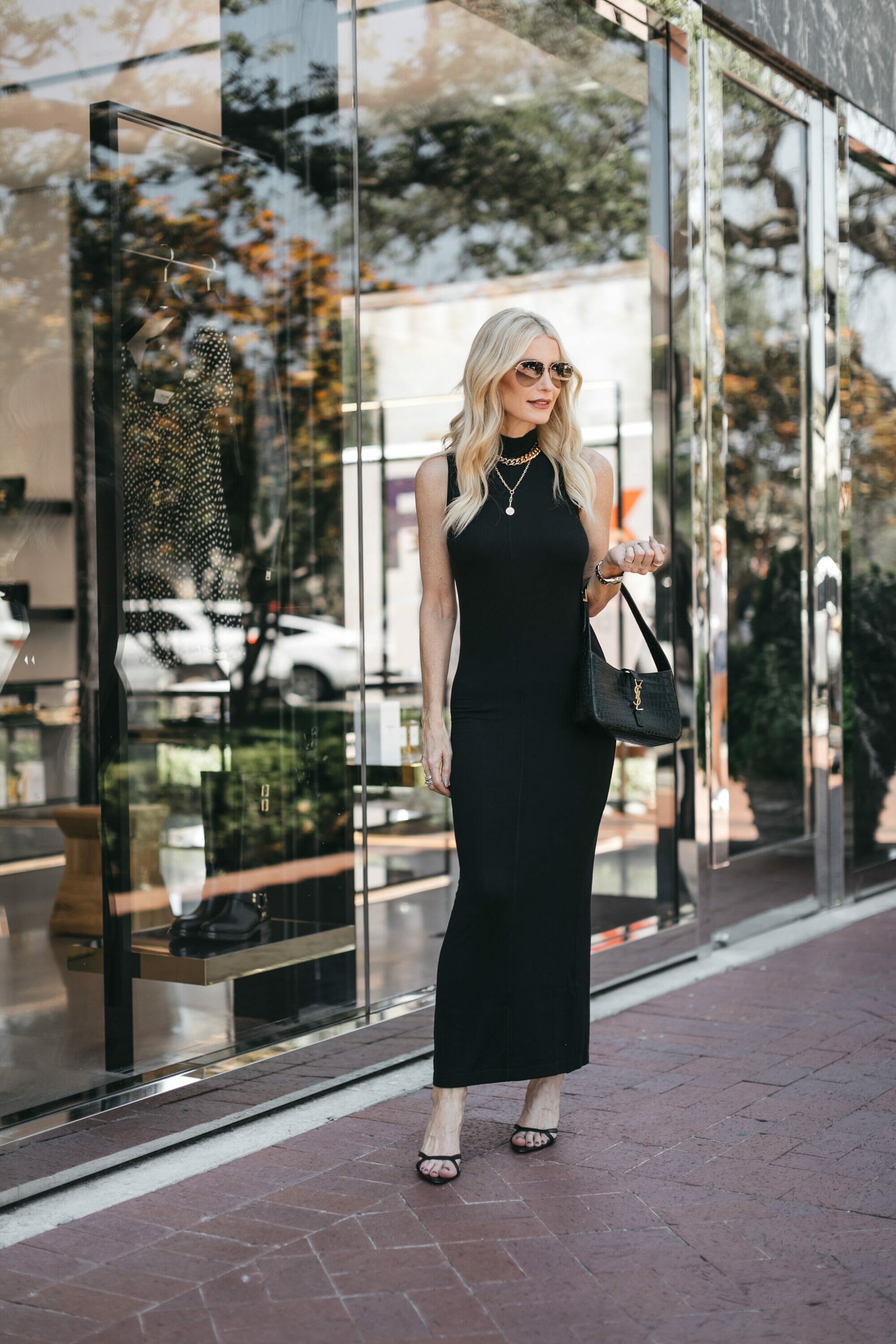 Dallas Fashion stylist for women over 40 wearing a black maxi dress with black heels and croc-embossed handbag.